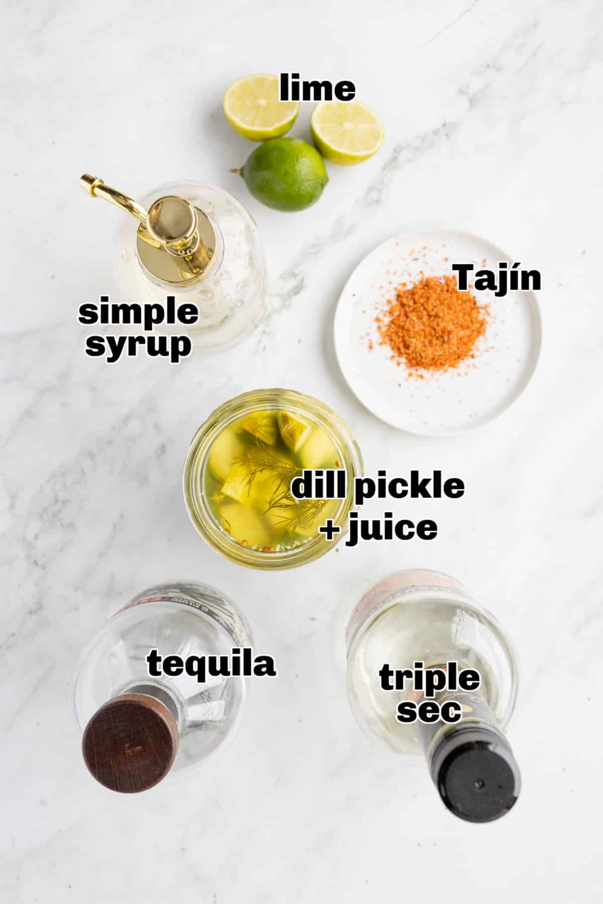 Dill Pickle Margarita Ingredients All ingredients for a dill pickle margarita arranged on a table