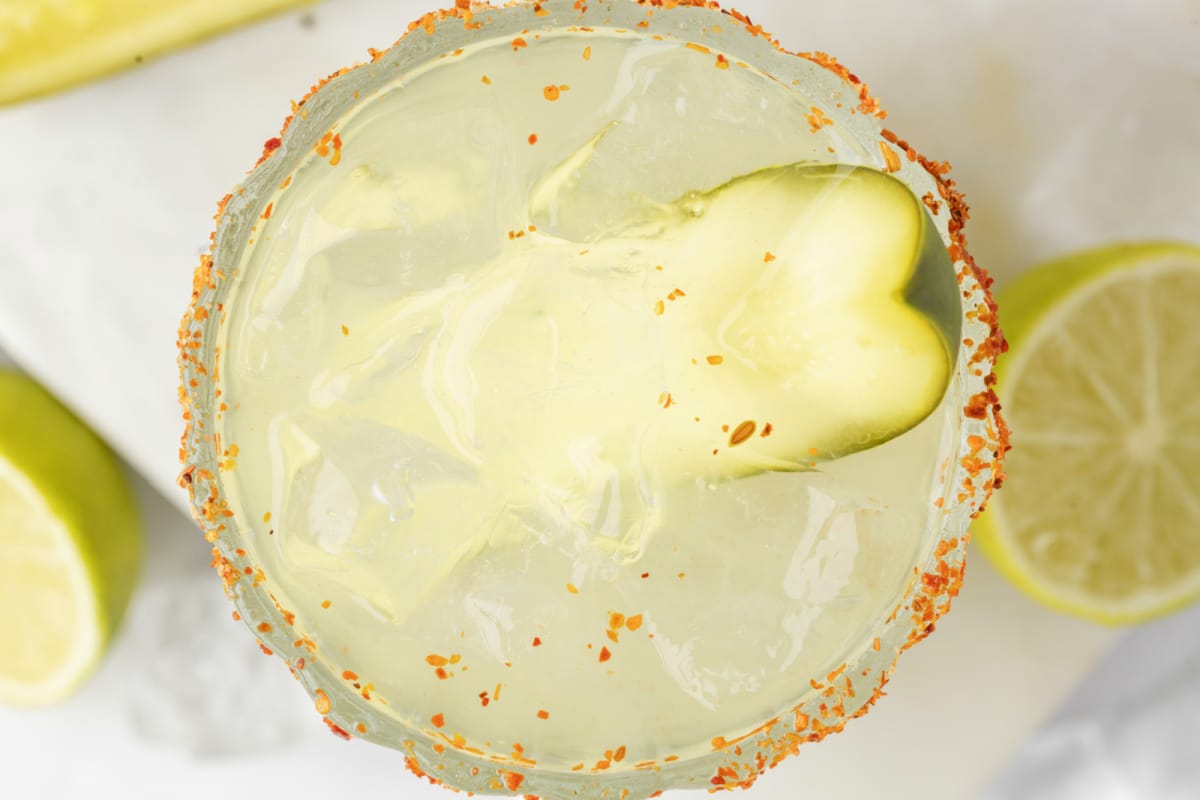Overhead View of Pickle Margarita with Garnish Overhead shot of dill pickle margarita garnished with a pickle spear
