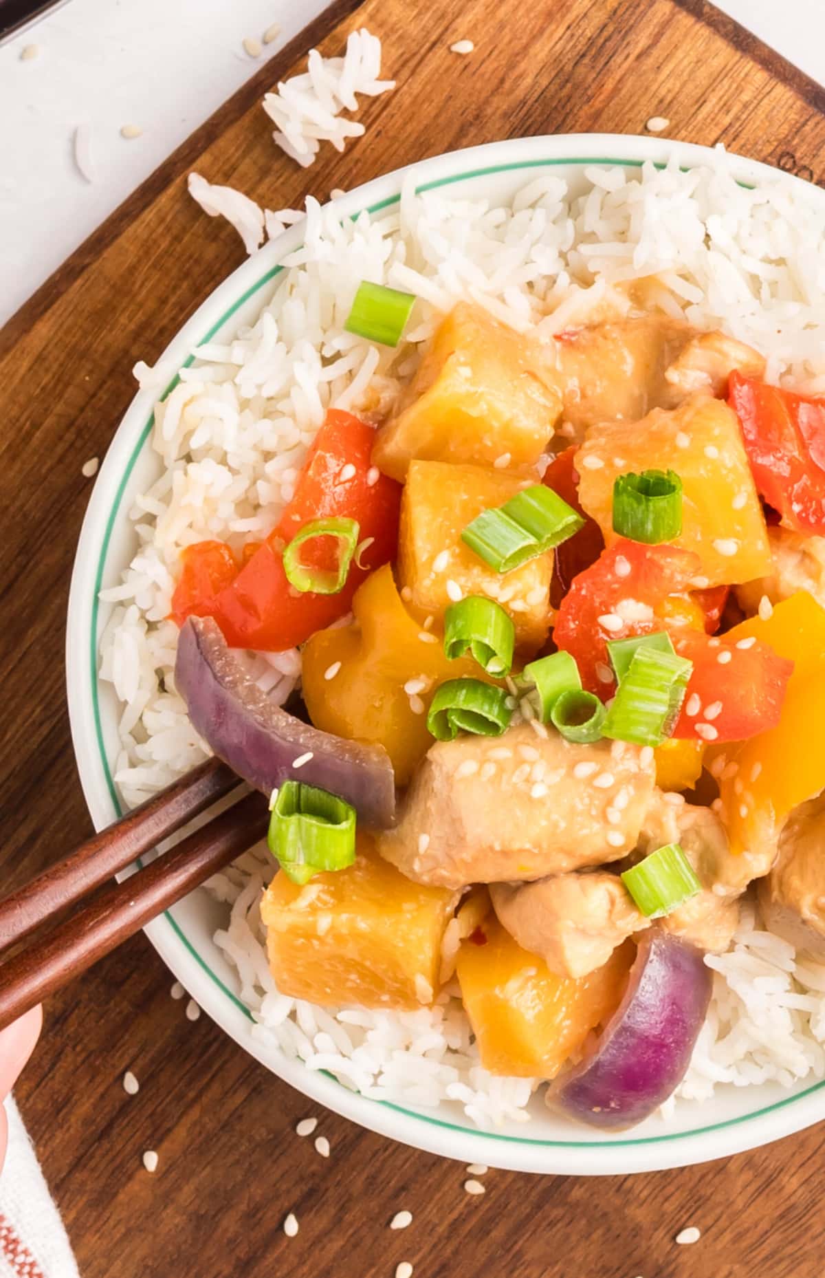 Pineapple Chicken over rice – easy weeknight dinner Saucy Hawaiian pineapple chicken served over white rice with sesame seeds