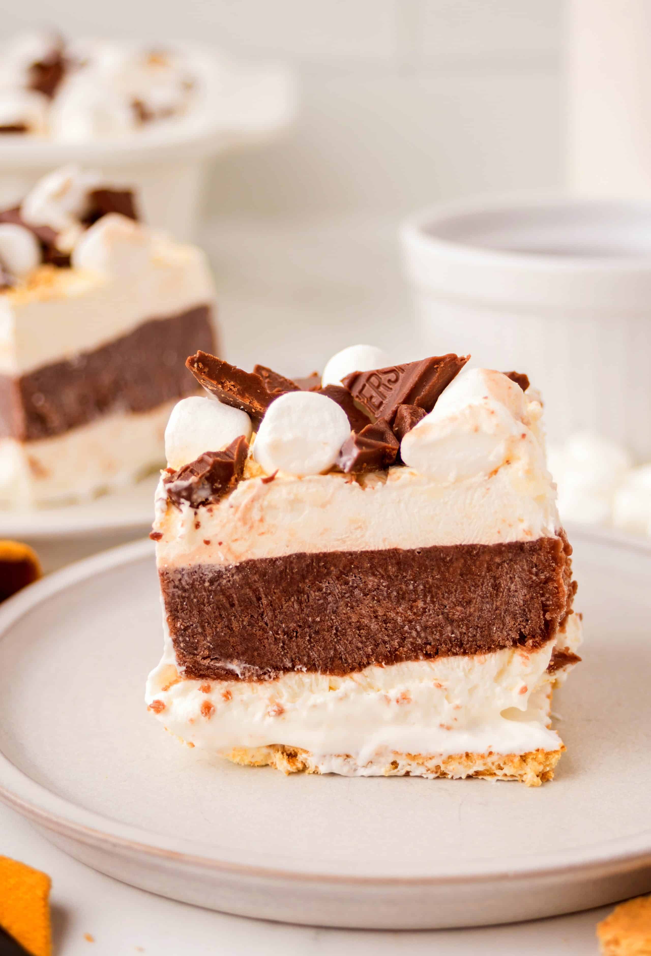 Thick slice of frozen s’mores lasagna with creamy and chocolate layers