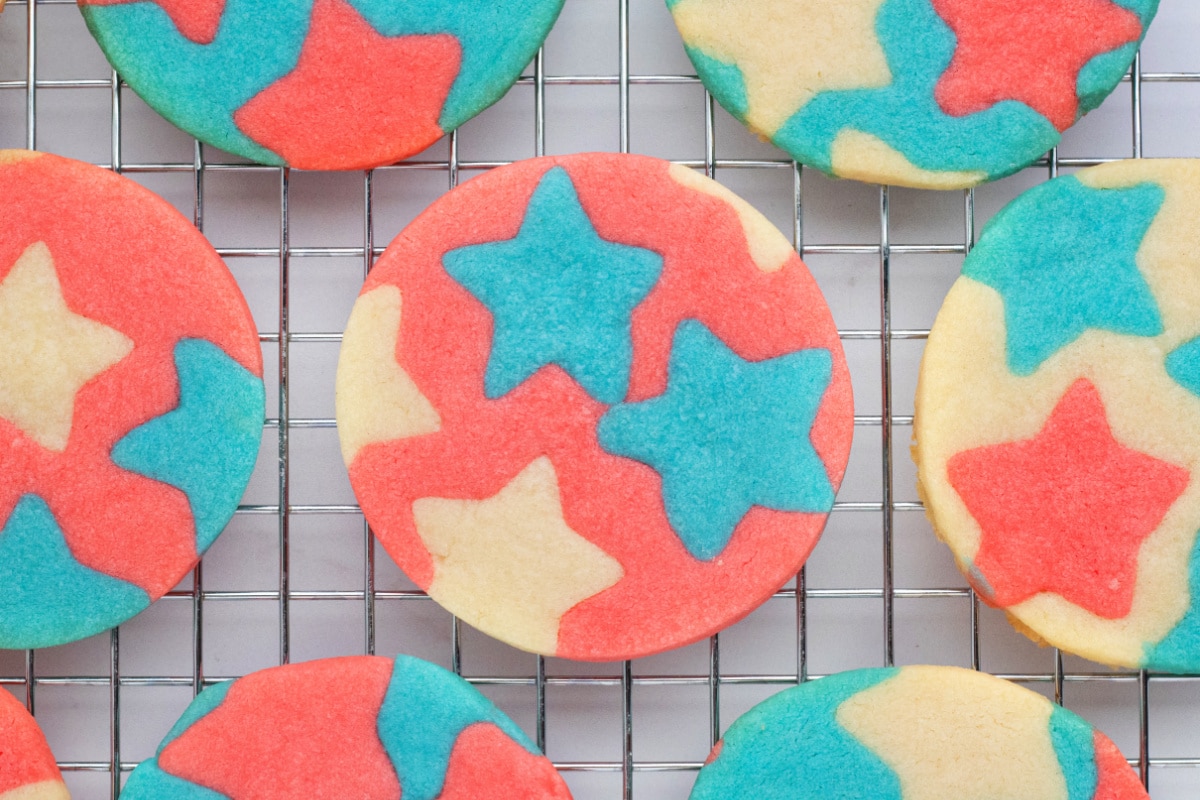 Patriotic star butter cookies cooling on wire rack Red, white, and blue butter cookies with star inlays cooling on a wire rack
