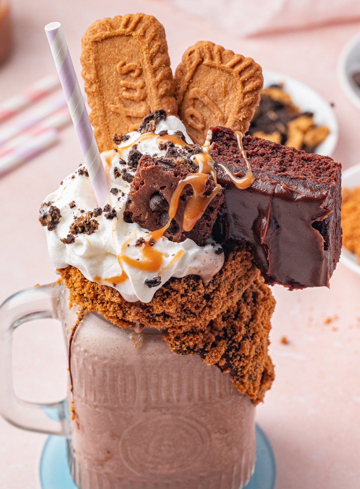 Over-the-top chocolate freakshake with Biscoff cookie rim and brownie topping Chocolate freakshake topped with brownies, Biscoff cookies, whipped cream, and caramel drizzle and toffee crunch