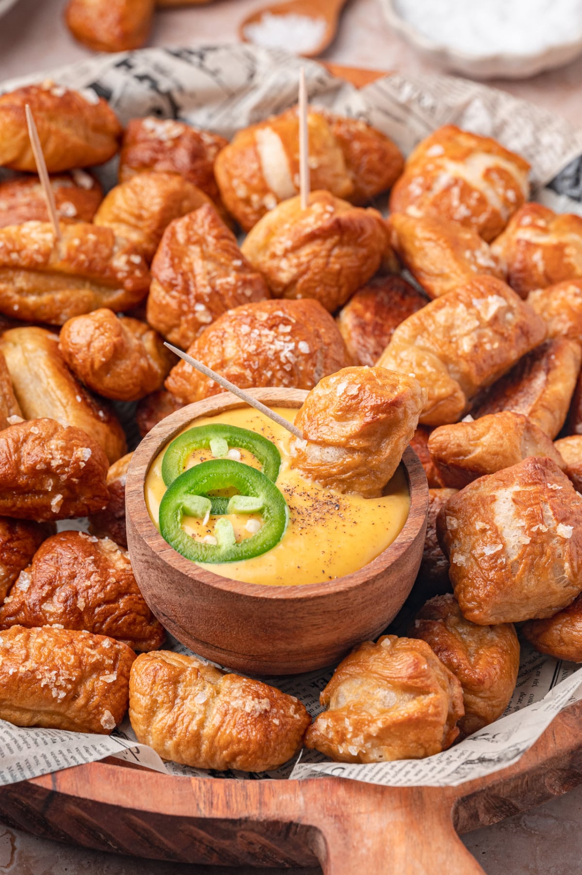 Homemade Pretzel Bites on a rustic serving board large batch of homemade soft pretzel bites on a wooden serving board