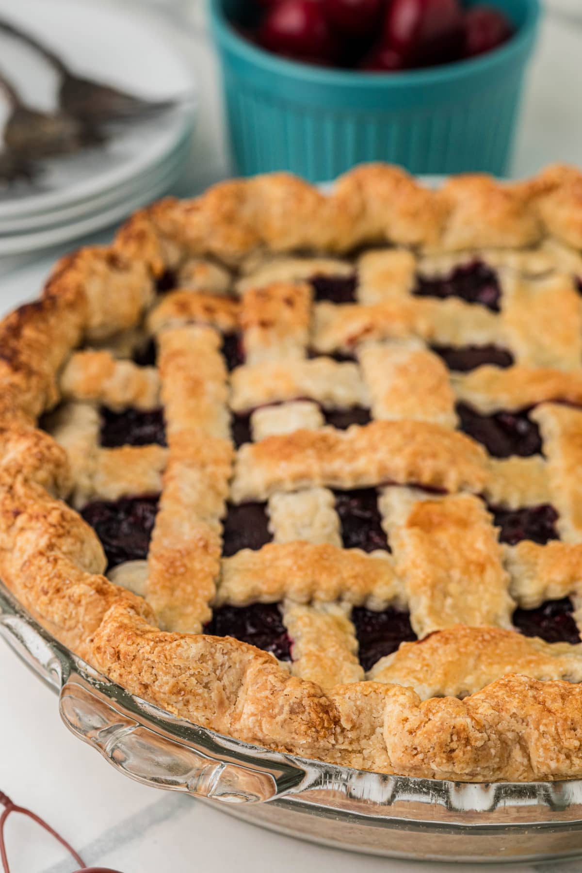 Angled view of Fresh Cherry Pie with a flaky homemade lattice crust and thick cherry filling