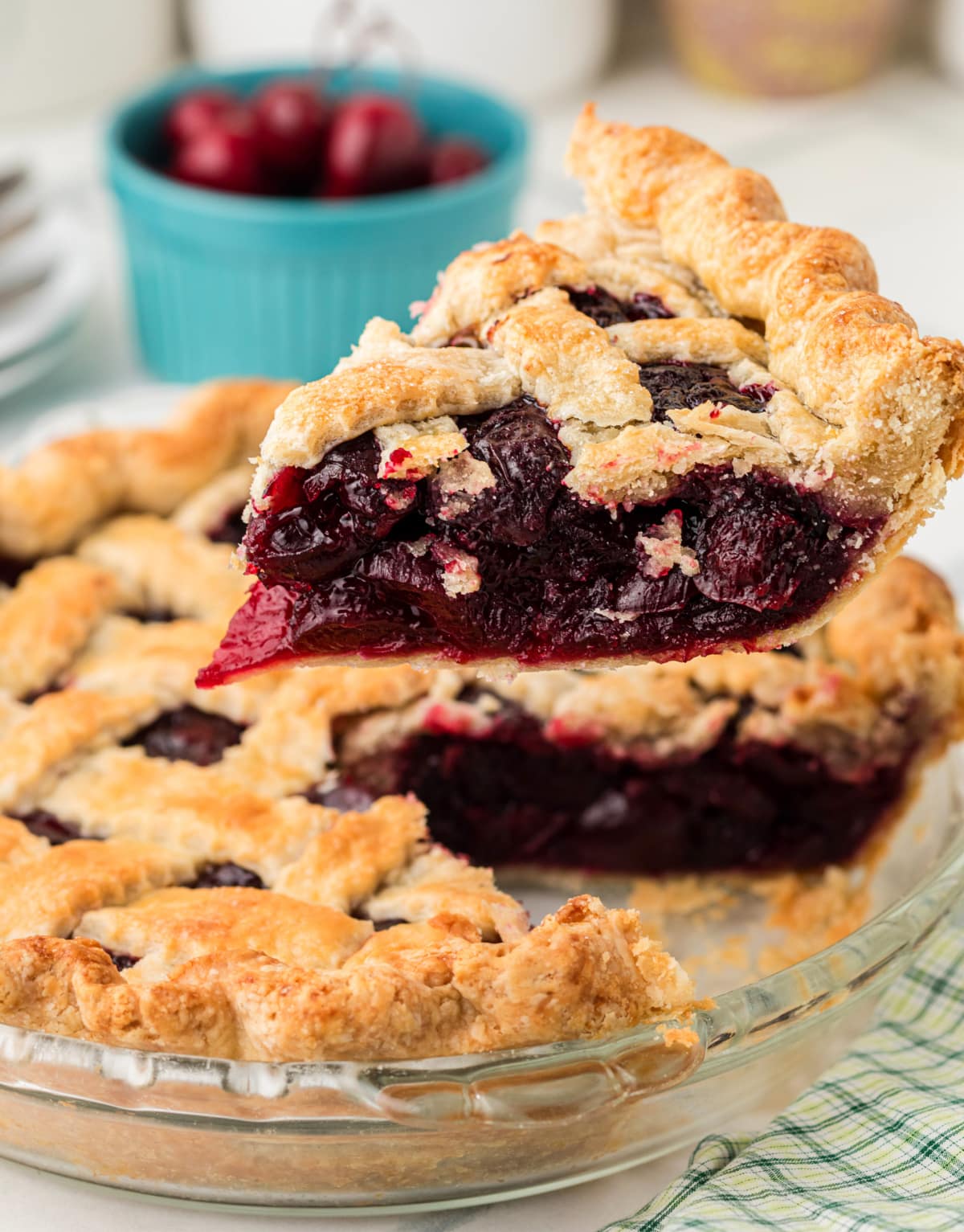 Fresh Cherry Pie slice lifted from the pie showing thick cherry filling and flaky homemade crust