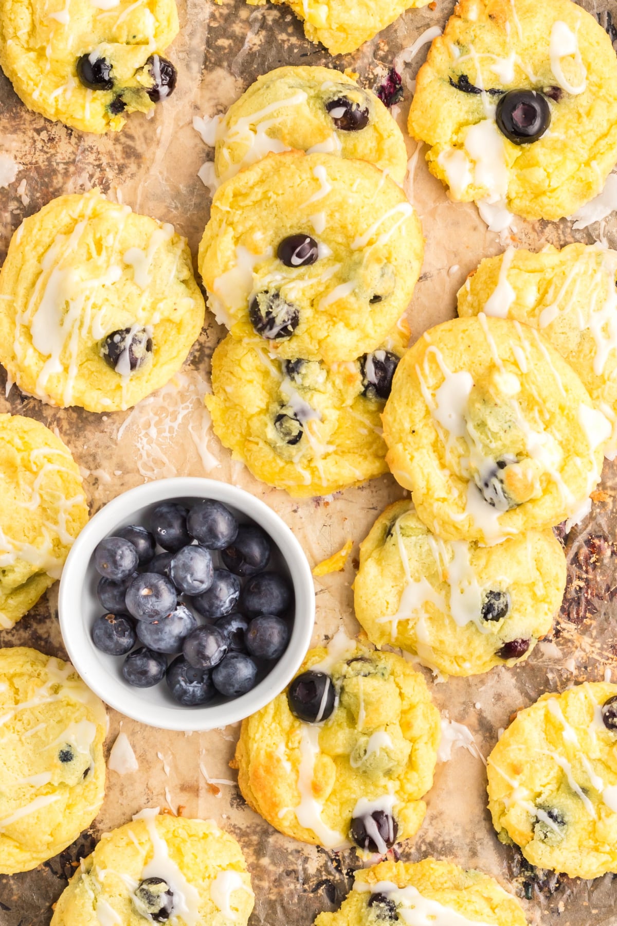 Lemon and Blueberry Cookies Overhead Overhead view of lemon and blueberry cookies with lemon glaze and a bowl of fresh blueberries