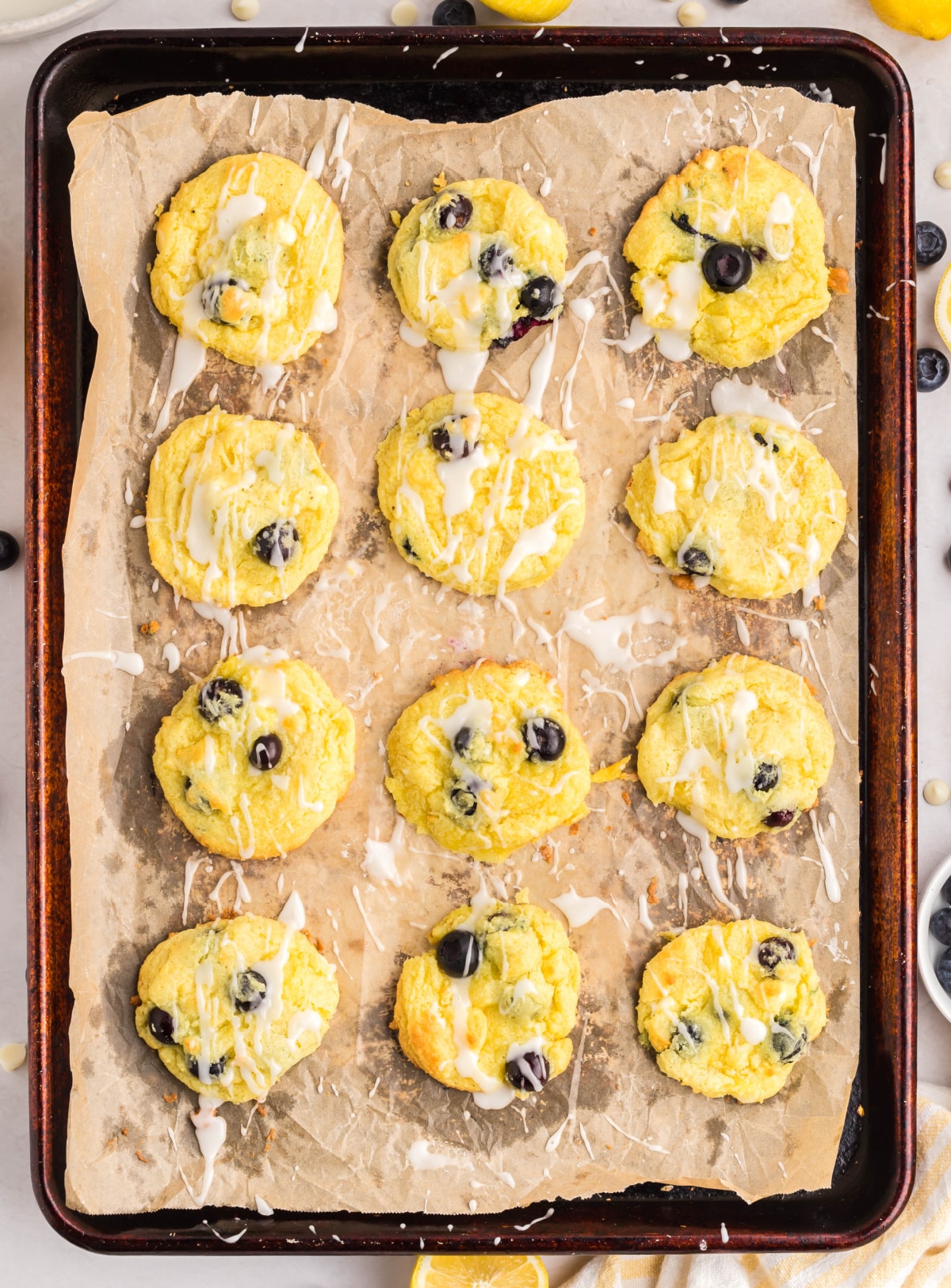 Lemon Blueberry Cake Mix Cookies Baked on Pan Full tray of lemon cake mix cookies with blueberries and glaze after baking