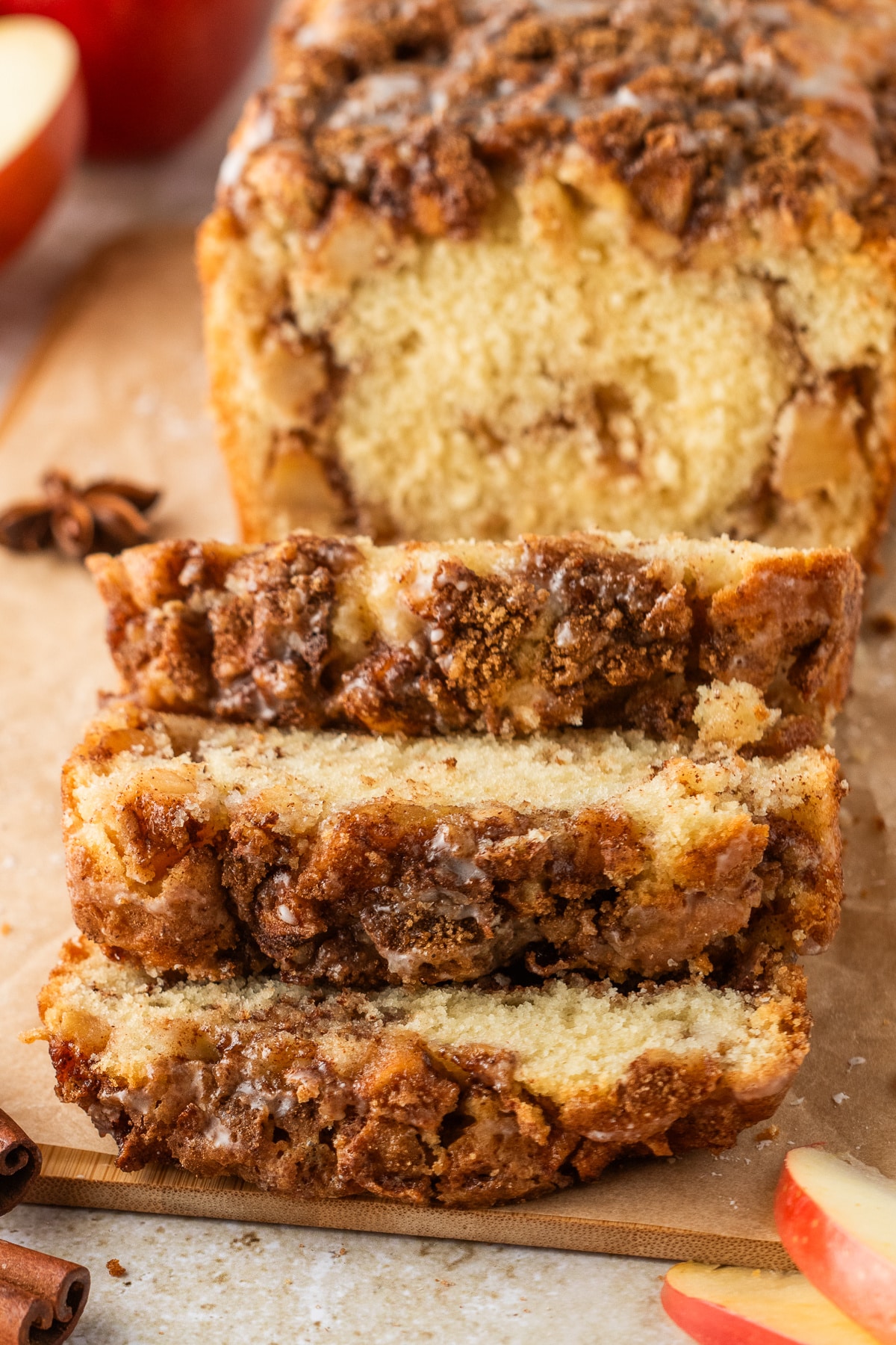 Old-fashioned apple fritter bread cut into slices with cinnamon sugar topping and glaze.