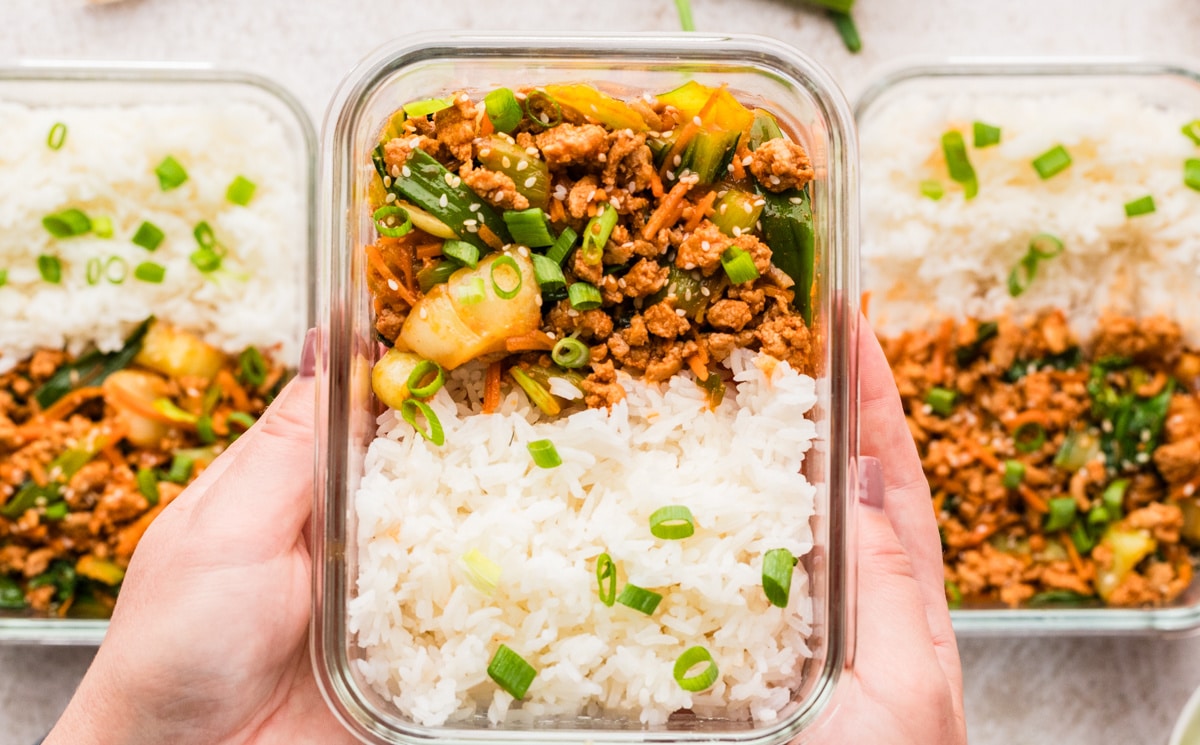 Ground turkey stir fry served with rice. Meal prep ground turkey stir fry with steamed rice and lime wedges.