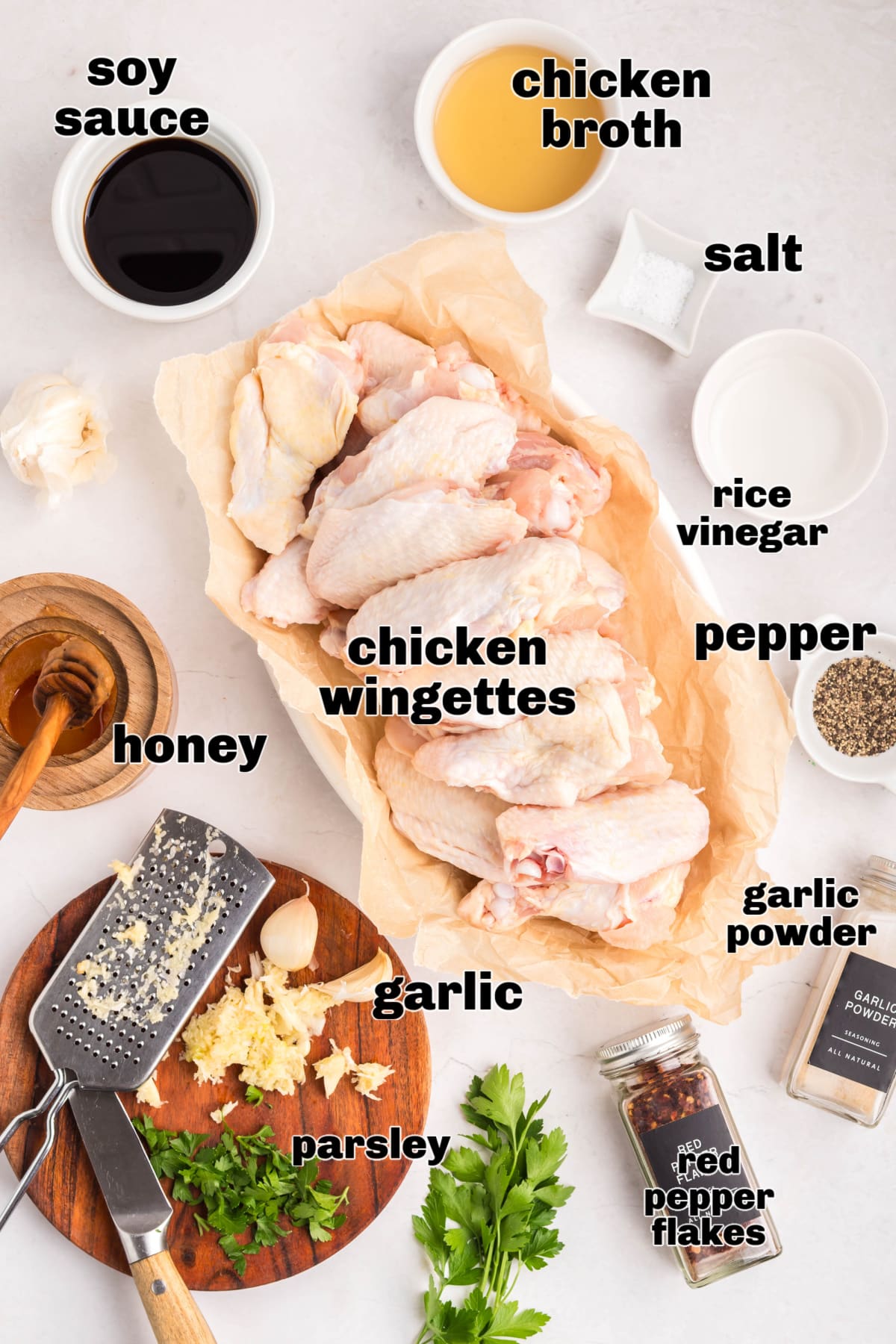Chicken wing marinade with honey soy garlic ingredients. Ingredients including soy sauce, vinegar, garlic, and chicken wingettes.