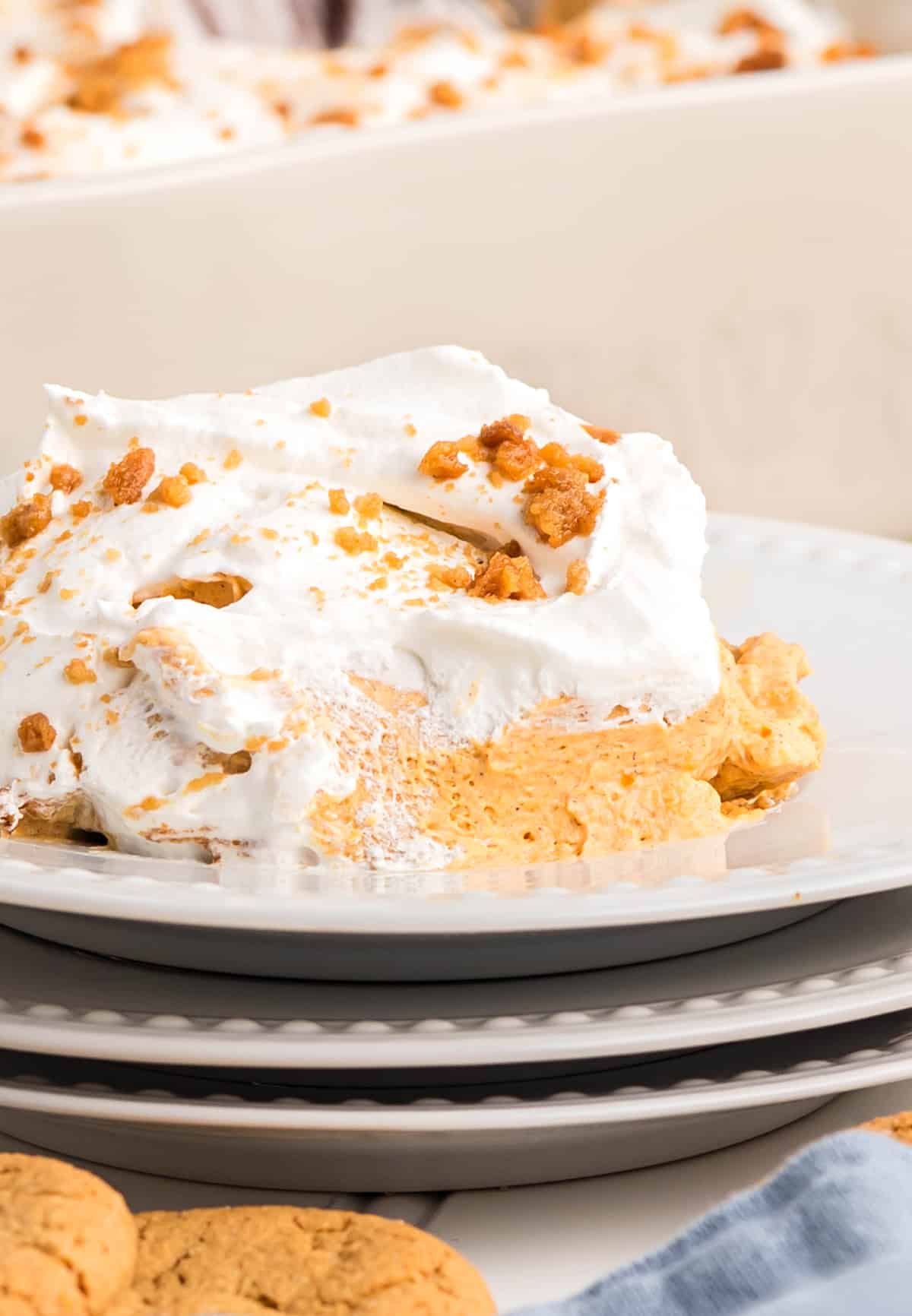 Cold pumpkin dessert slice with creamy layers and cookie crumbs