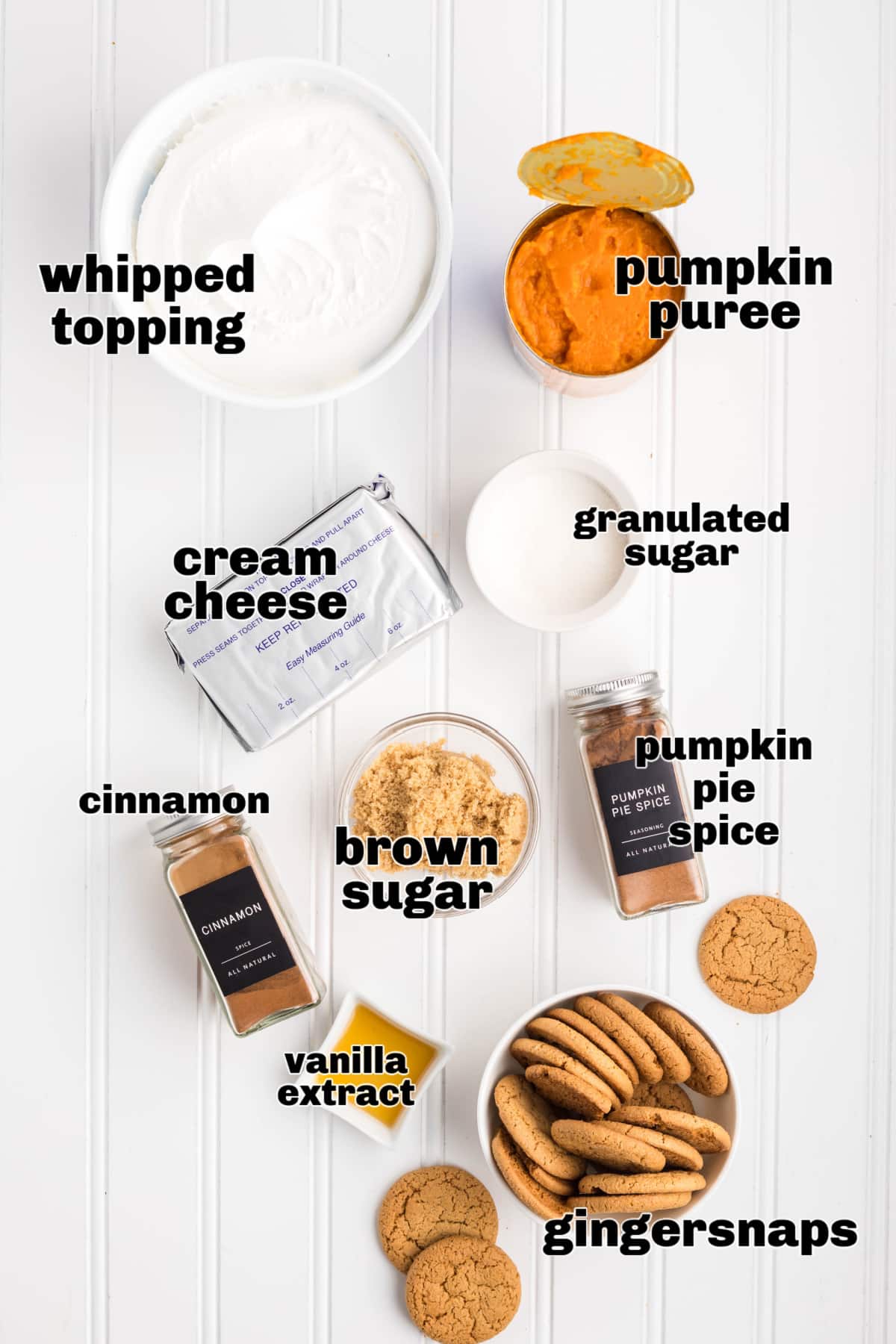 Ingredients for pumpkin refrigerator cake including pumpkin puree, cream cheese, spices, and gingersnaps