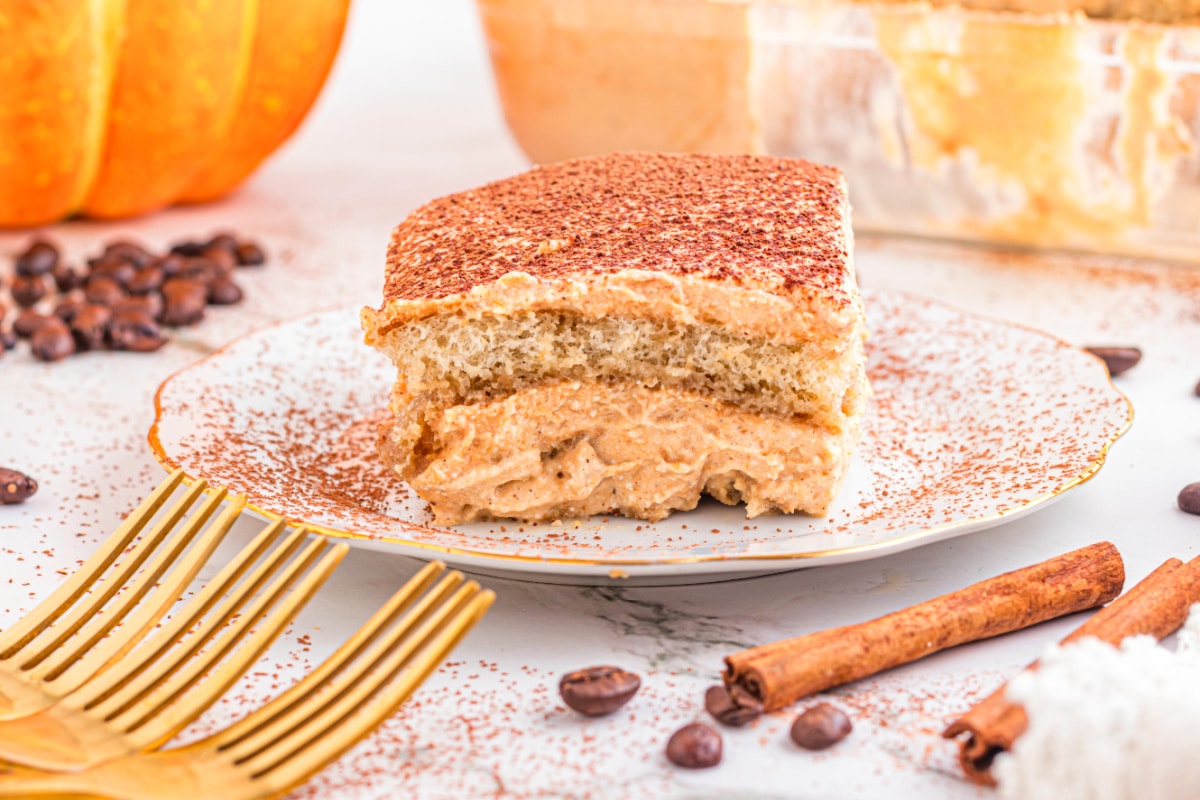 creamy pumpkin dessert plated Creamy pumpkin dessert slice served with cinnamon sticks and coffee beans