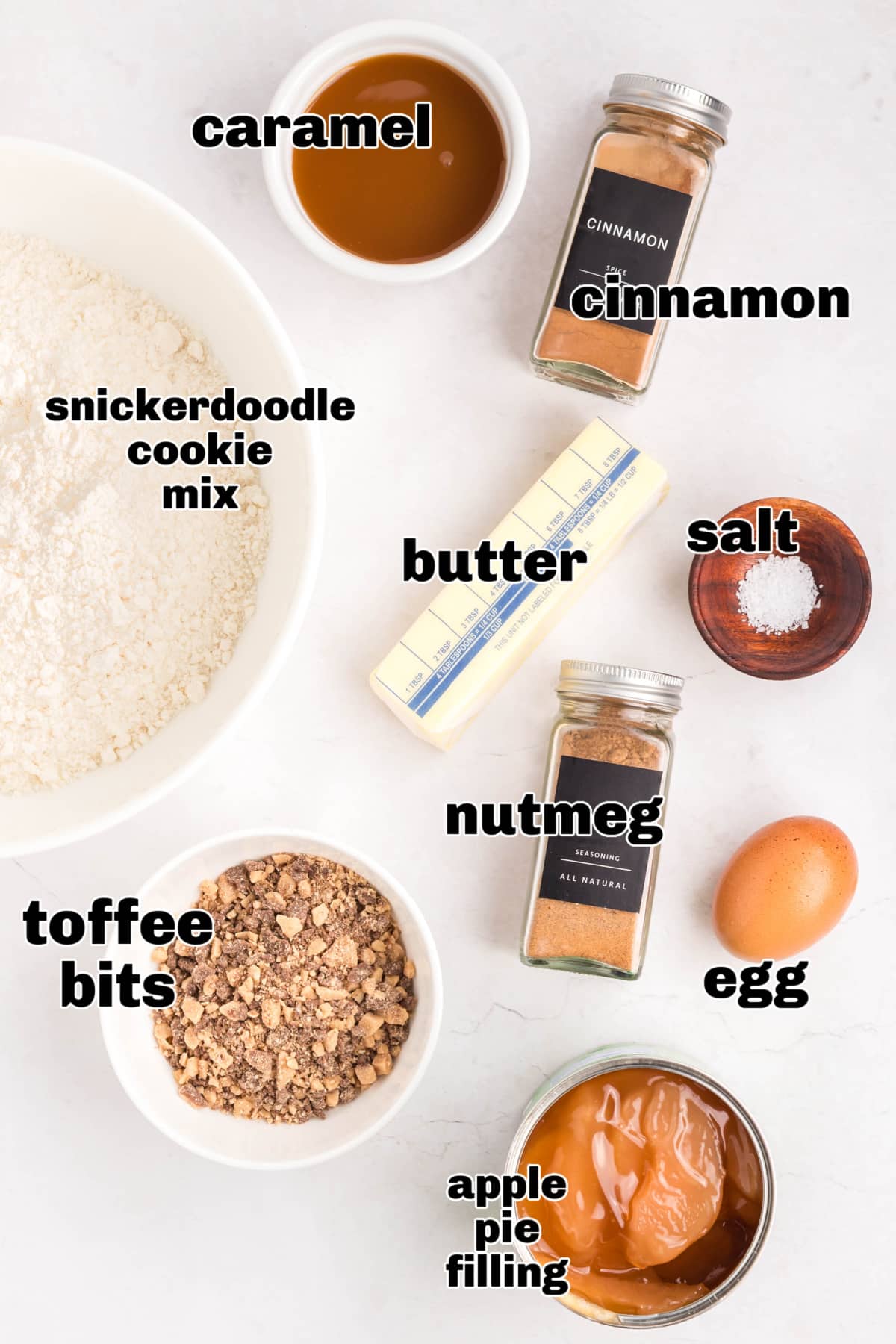 Ingredients for apple cobbler with cookie topping, including snickerdoodle mix, spices, toffee, and apples.