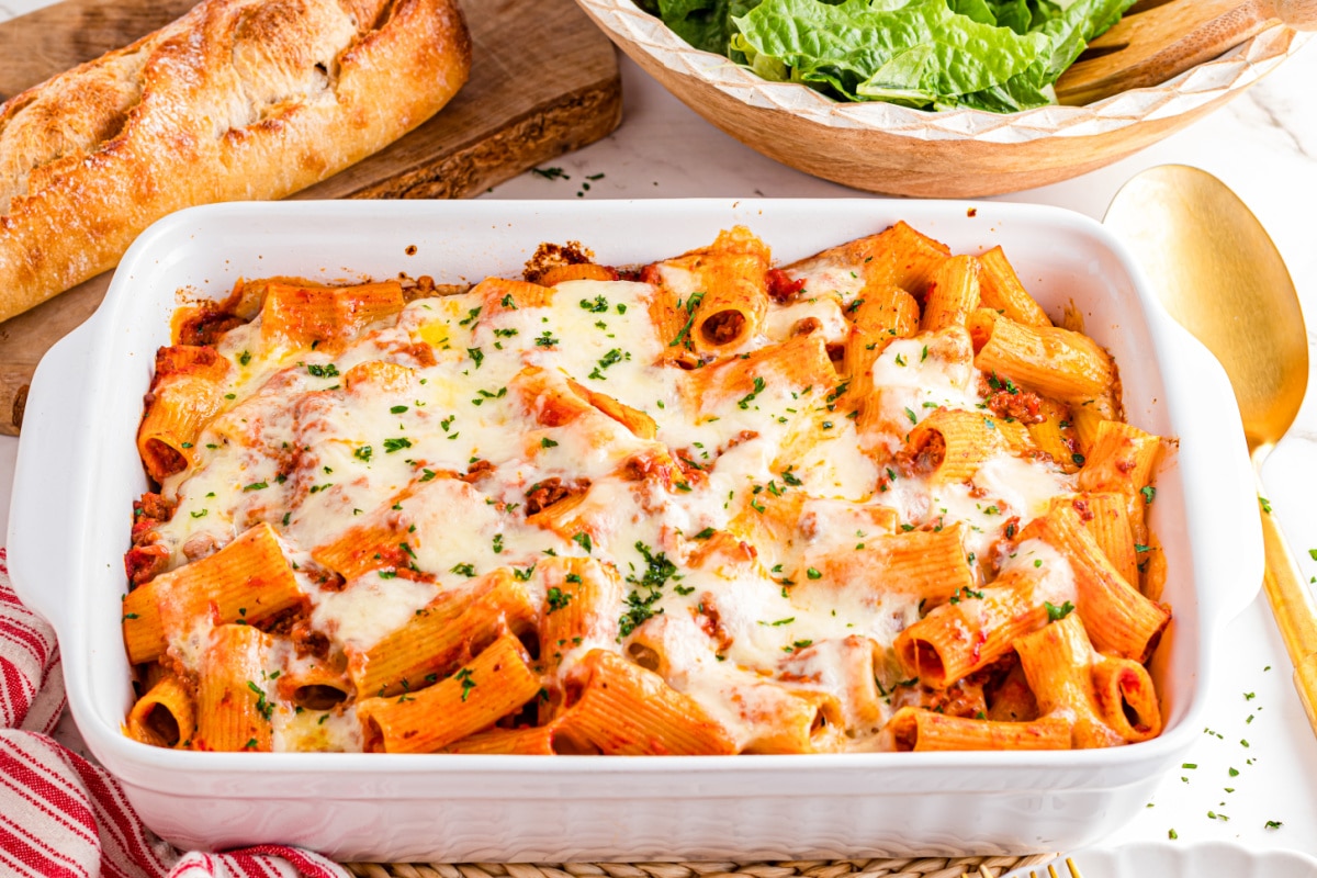 Baked rigatoni with beef, mozzarella, and Parmesan in red sauce baked until bubbling and golden by Noble Pig