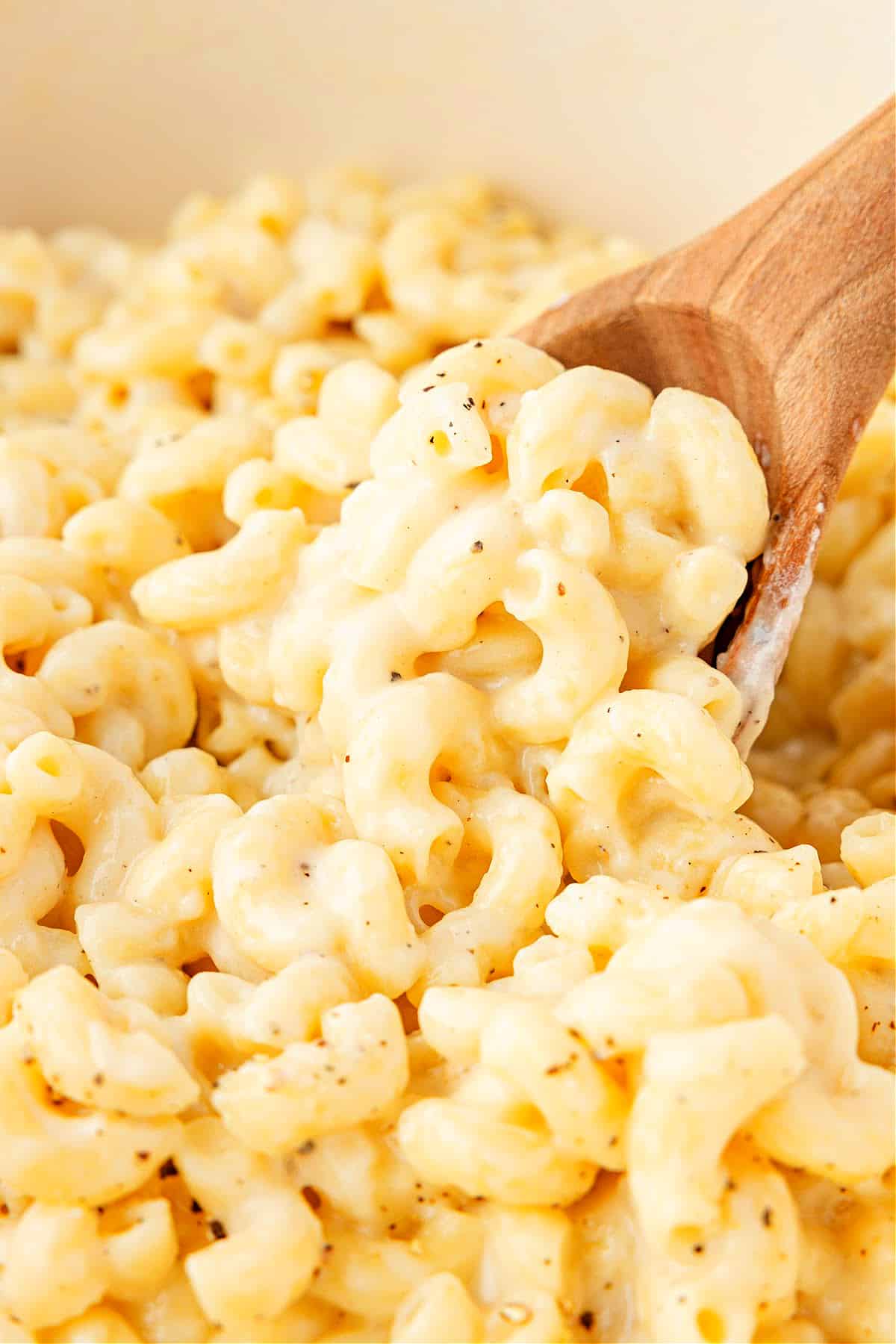 Stovetop cottage cheese mac and cheese. Stovetop cottage cheese mac and cheese in a pot, stirred with a wooden spoon until creamy and cheesy.