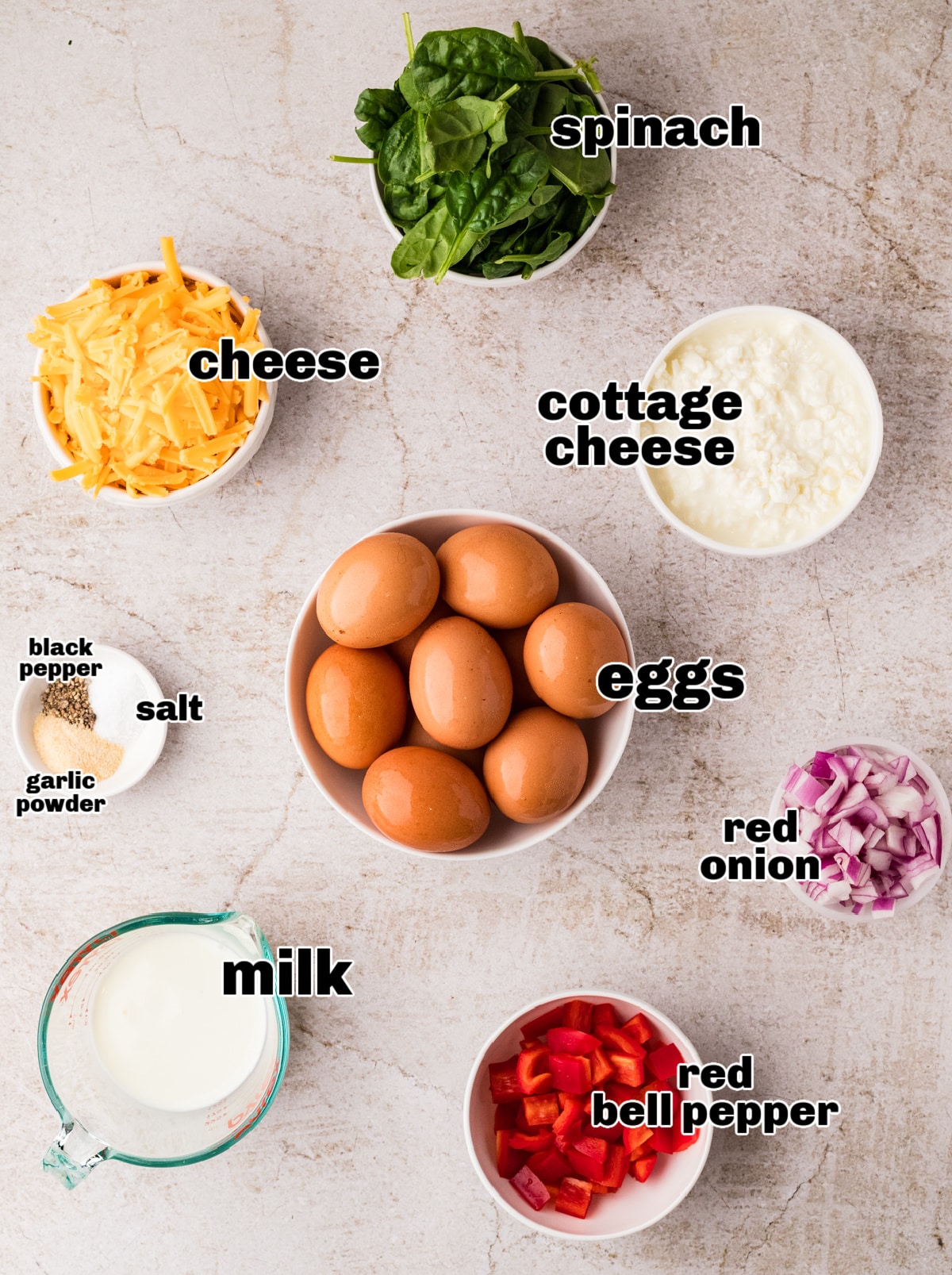 Ingredients for egg bake recipe Ingredients for cottage cheese breakfast casserole including eggs, spinach, peppers, onion, and cheese