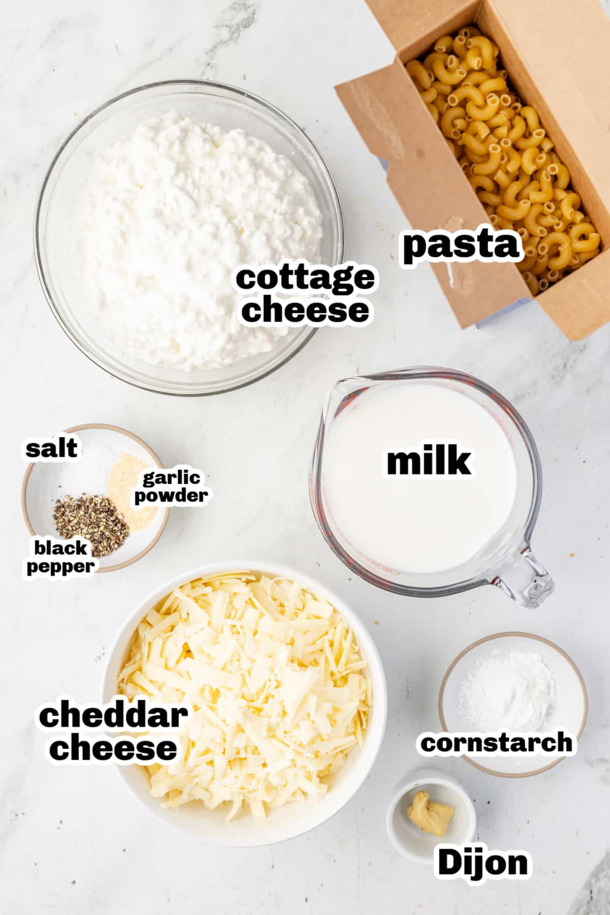 Ingredients for cottage cheese mac and cheese. Ingredients for cottage cheese mac and cheese including cheddar cheese, milk, cornstarch, and Dijon mustard.
