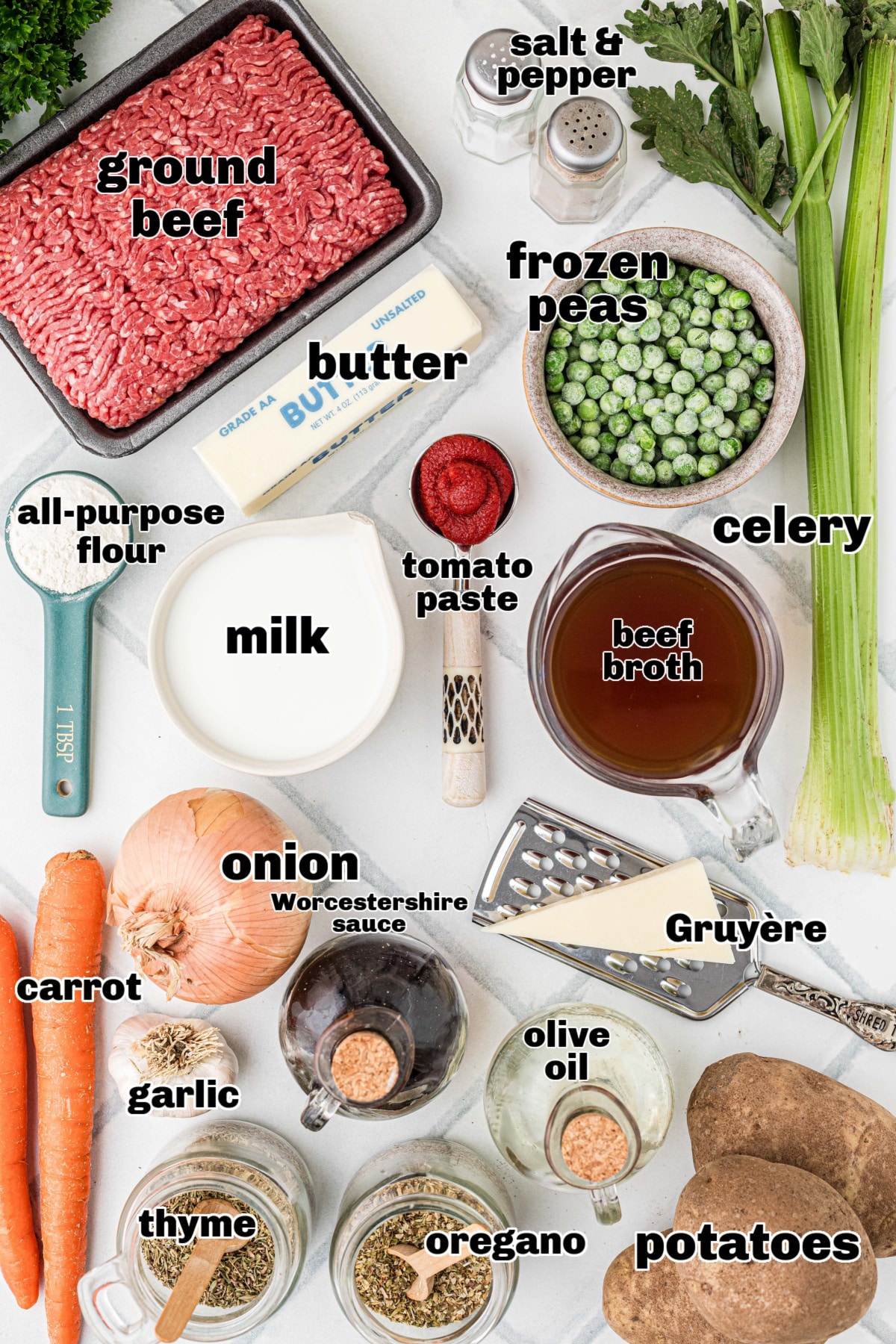 cottage pie ingredients with beef potatoes and vegetables Ingredients for cottage pie with Gruyère mashed potatoes arranged on a counter, including ground beef, potatoes, peas, carrots, onion, celery, and butter.