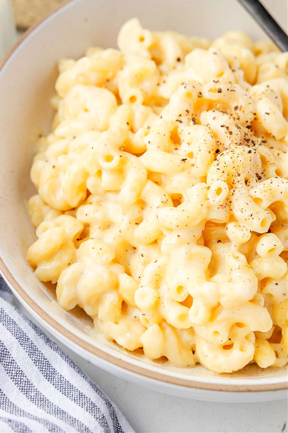 Creamy cottage cheese mac and cheese. Creamy cottage cheese mac and cheese in a bowl topped with cracked black pepper.