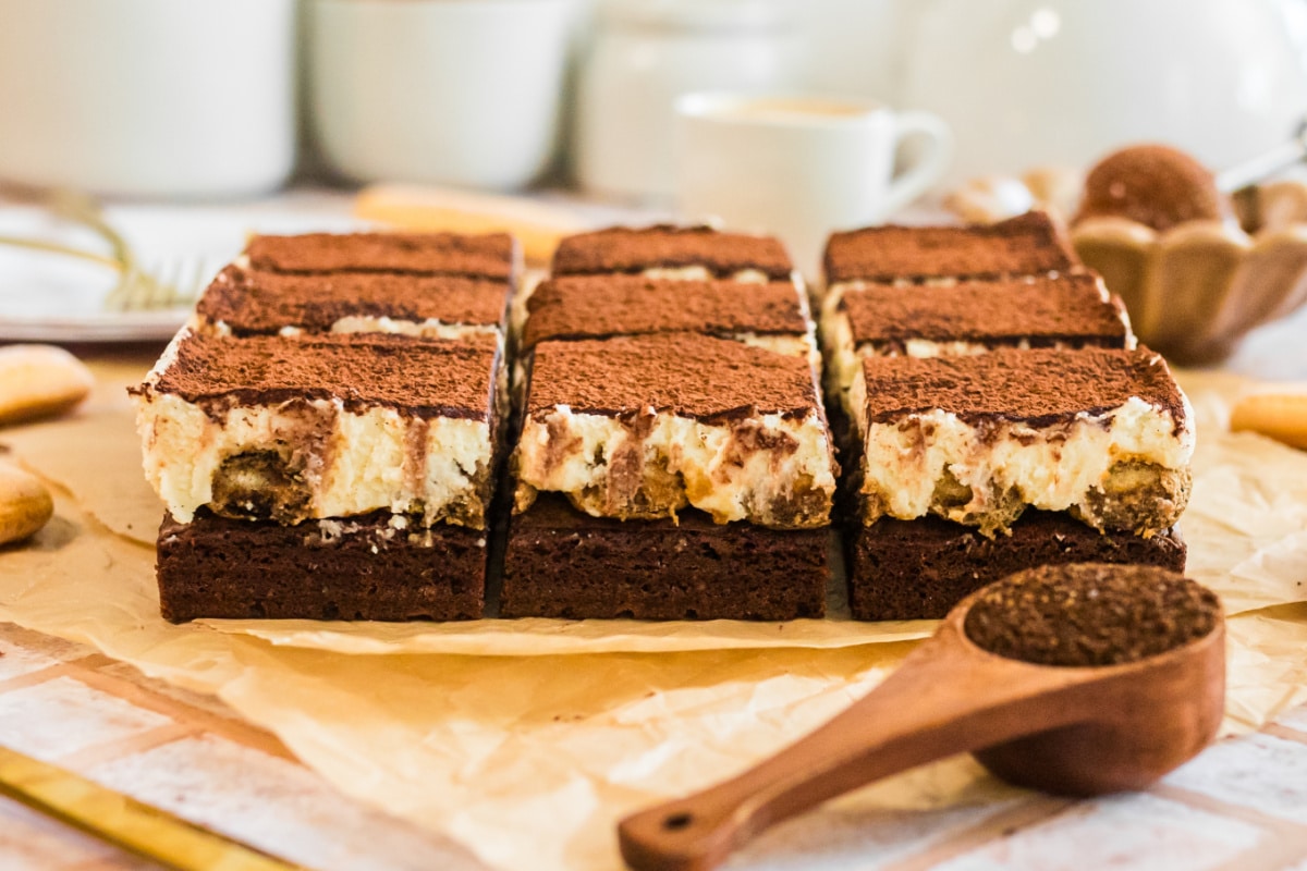 tray of tiramisu brownies with rich cocoa dusting and creamy mascarpone layers.