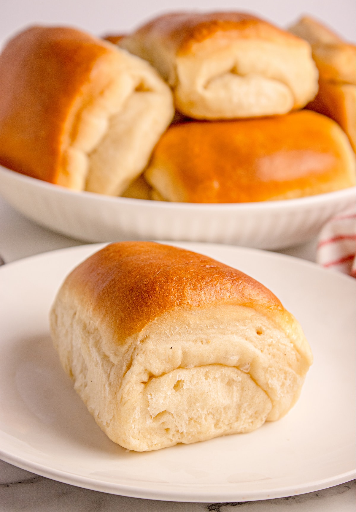 Parker House Roll on a plate highlighting the buttery fold and soft dinner-roll crumb.
