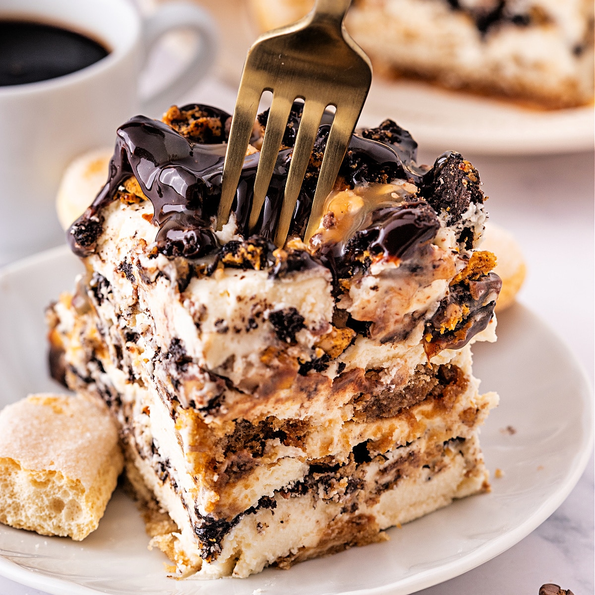 Easy toffee tiramisu with espresso, mascarpone cream, caramel drizzle, and crushed Toffee Crunch OREOs.
