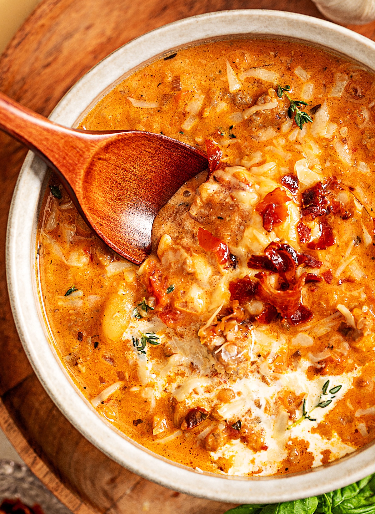 Marry Me White Bean and Sausage Soup by Noble Pig, a creamy Tuscan-style soup with sausage, white beans, sun-dried tomatoes, and crisped prosciutto in a light ceramic bowl.