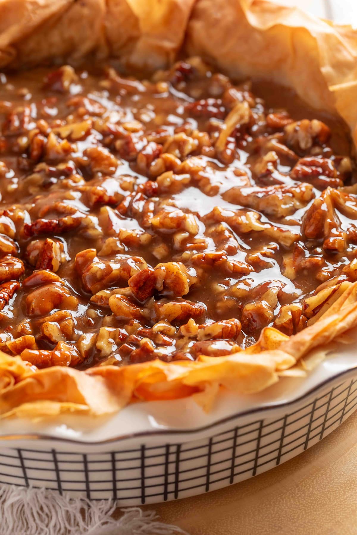 A whole pumpkin praline pie with a ruffled phyllo crust.