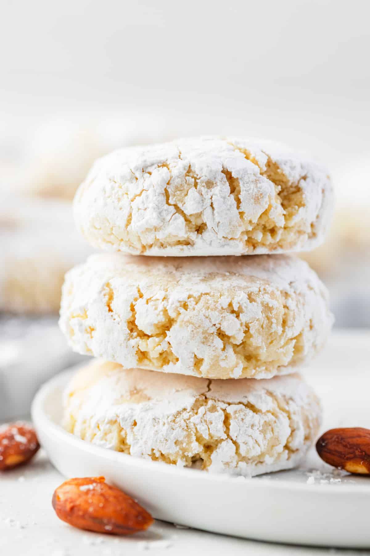A soft amaretti-style almond cookie broken open to show its tender, chewy center.