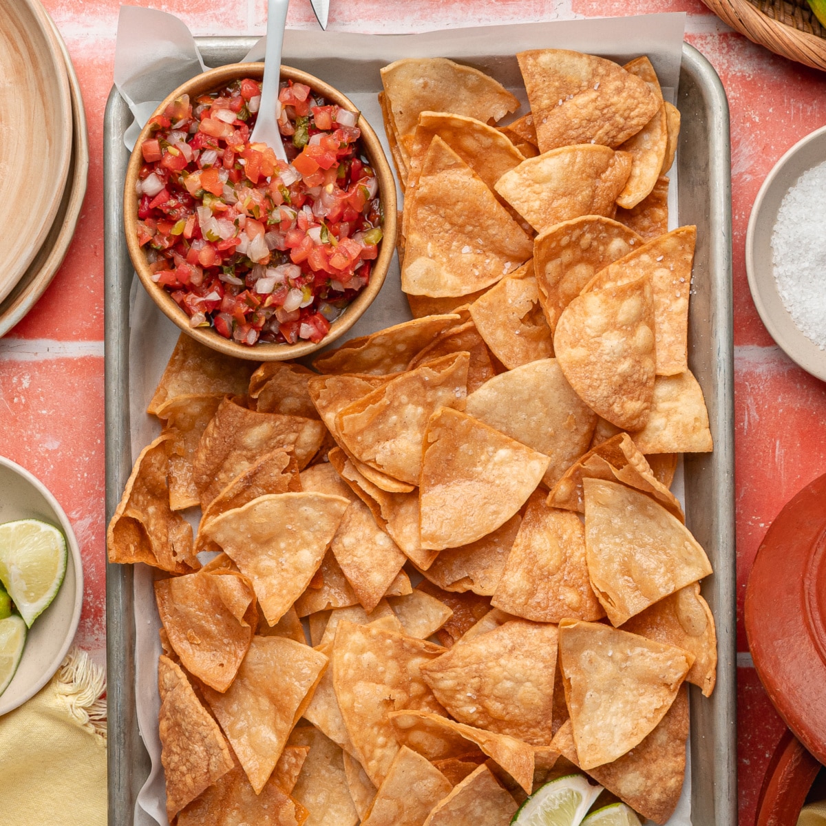 Easy fried tortilla chips served with guacamole and salsa on a tray.