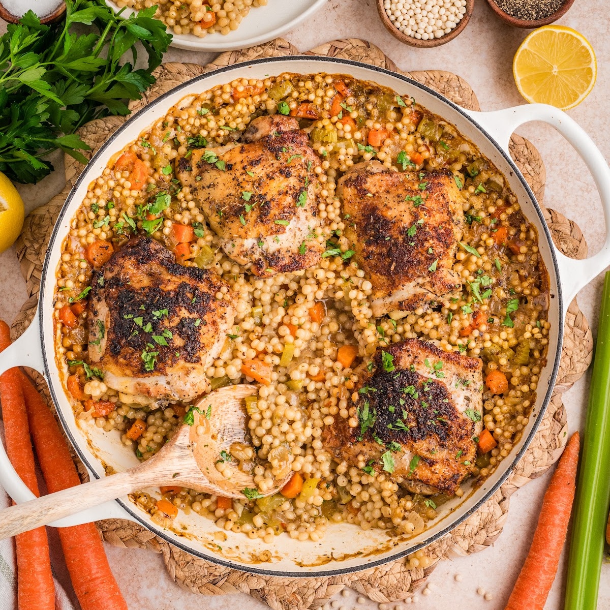 Crispy chicken thighs with pearl couscous cooked until golden and juicy, with tender vegetables and savory pan juices.