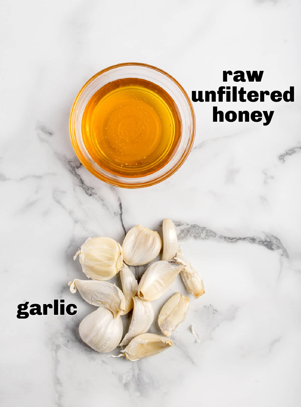 Raw unfiltered honey and fresh garlic cloves arranged as the ingredients for a honey garlic ferment. Raw unfiltered honey and whole garlic cloves shown side by side as the two ingredients used for fermentation.