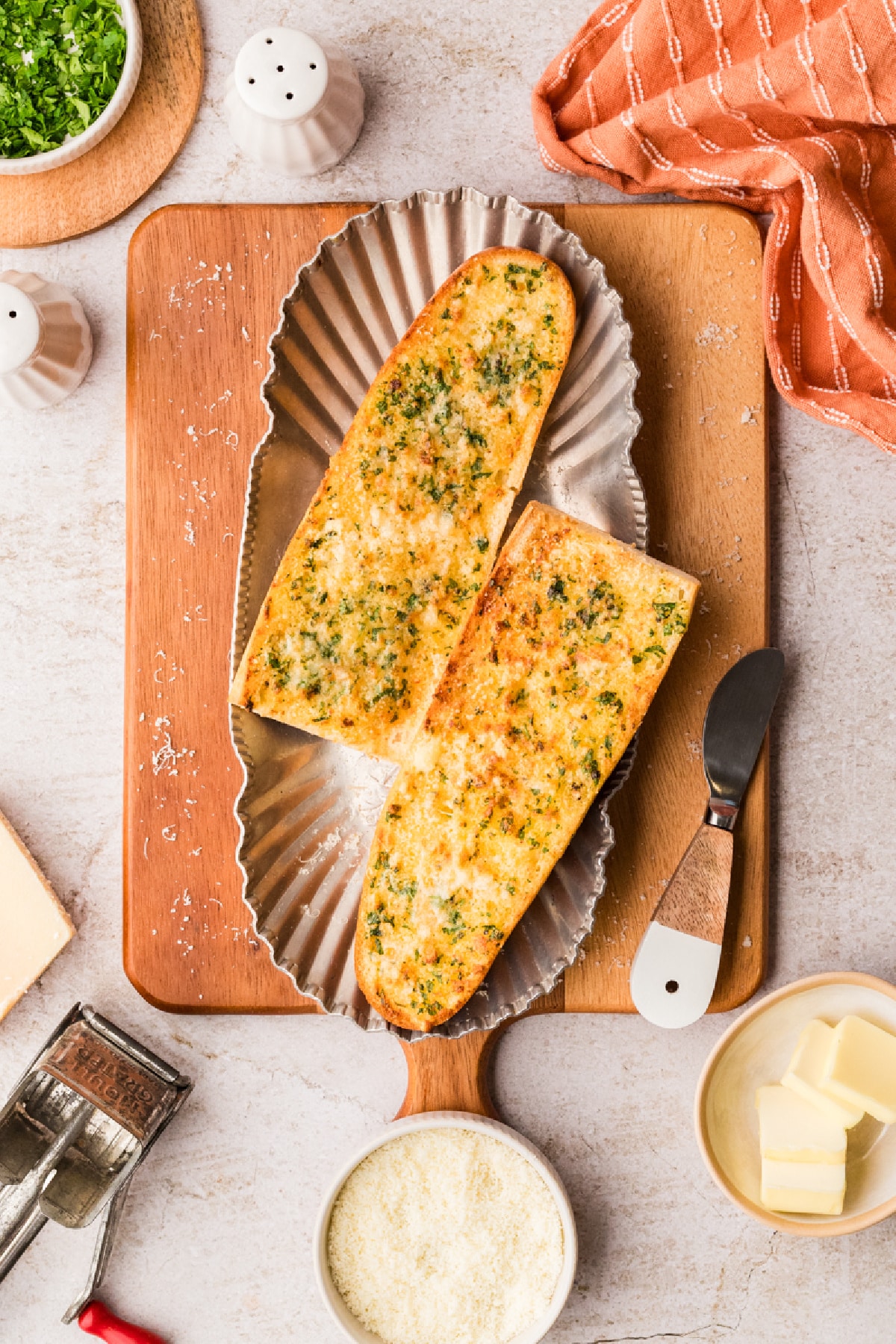 Finished garlic confit air fryer bread resting on a platter, crisp on the outside and soft inside Garlic confit air fryer bread served warm with golden edges, Parmesan, and parsley