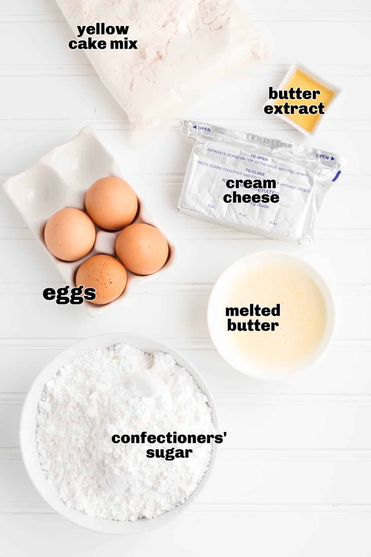 Ingredients for cream cheese butter cake including cake mix, cream cheese, eggs, and butter. Ingredients for a classic cream cheese butter cake including yellow cake mix, cream cheese, eggs, melted butter, butter extract, and confectioners’ sugar.