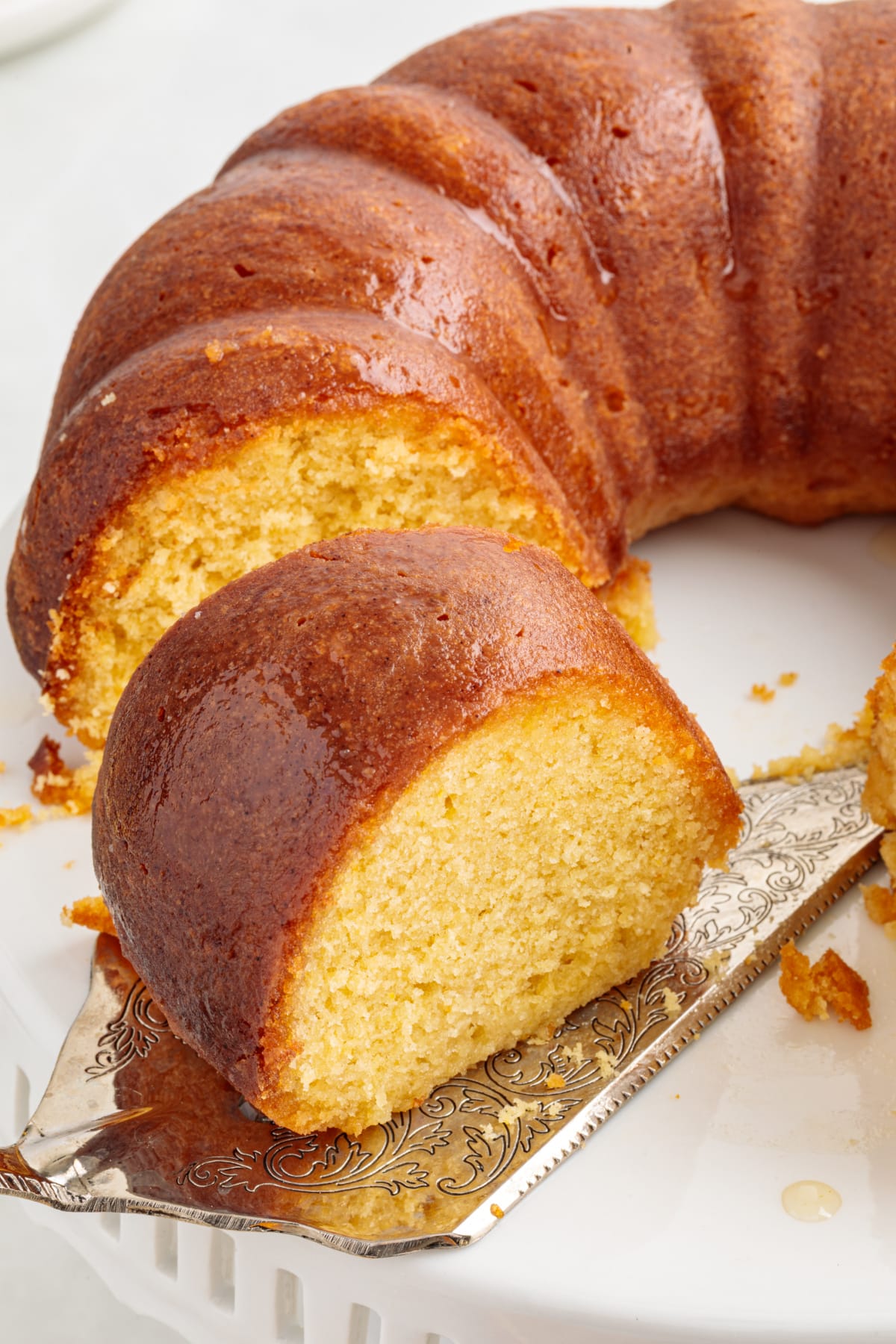 Italian Hangover Cake sliced Bundt cake Italian Hangover Cake sliced to show a golden, syrup-soaked crumb in a Bundt cake.
