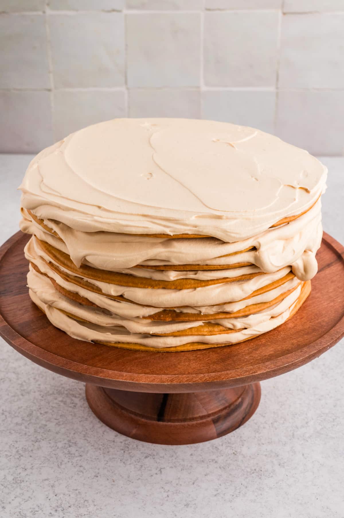 Russian honey cake (Medovik) assembled with thin honey layers and whipped dulce de leche frosting before chilling.