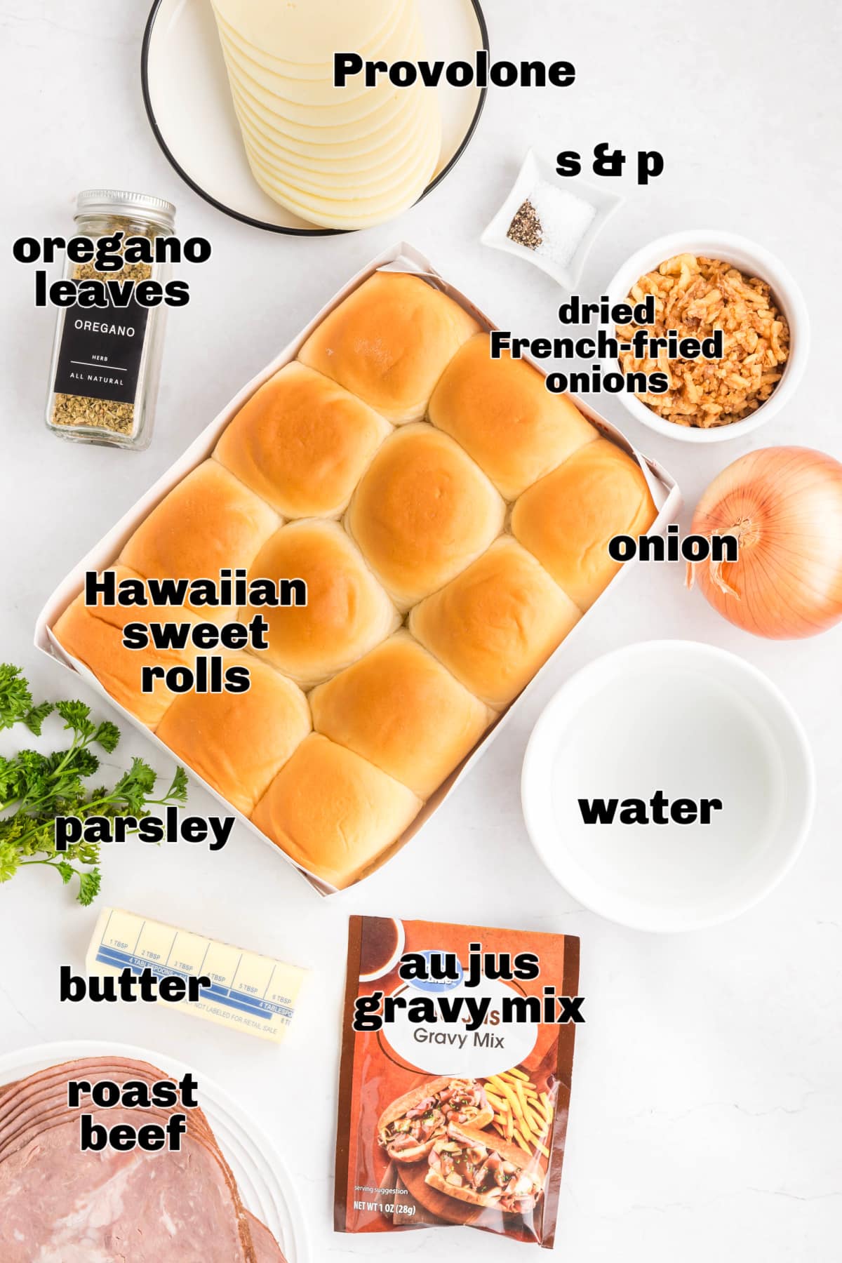 Ingredients for French dip sliders shown in a flat lay with sweet rolls, sliced roast beef, provolone cheese, yellow onion, butter, oregano, parsley, French-fried onions, water, and au jus gravy mix French dip sliders ingredients including Hawaiian sweet rolls, roast beef, provolone, onion, butter, and au jus gravy mix
