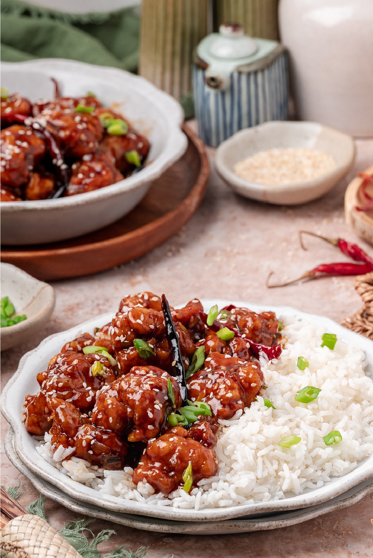 General Tso’s chicken served over white rice with scallions, sesame seeds, and dried chilies