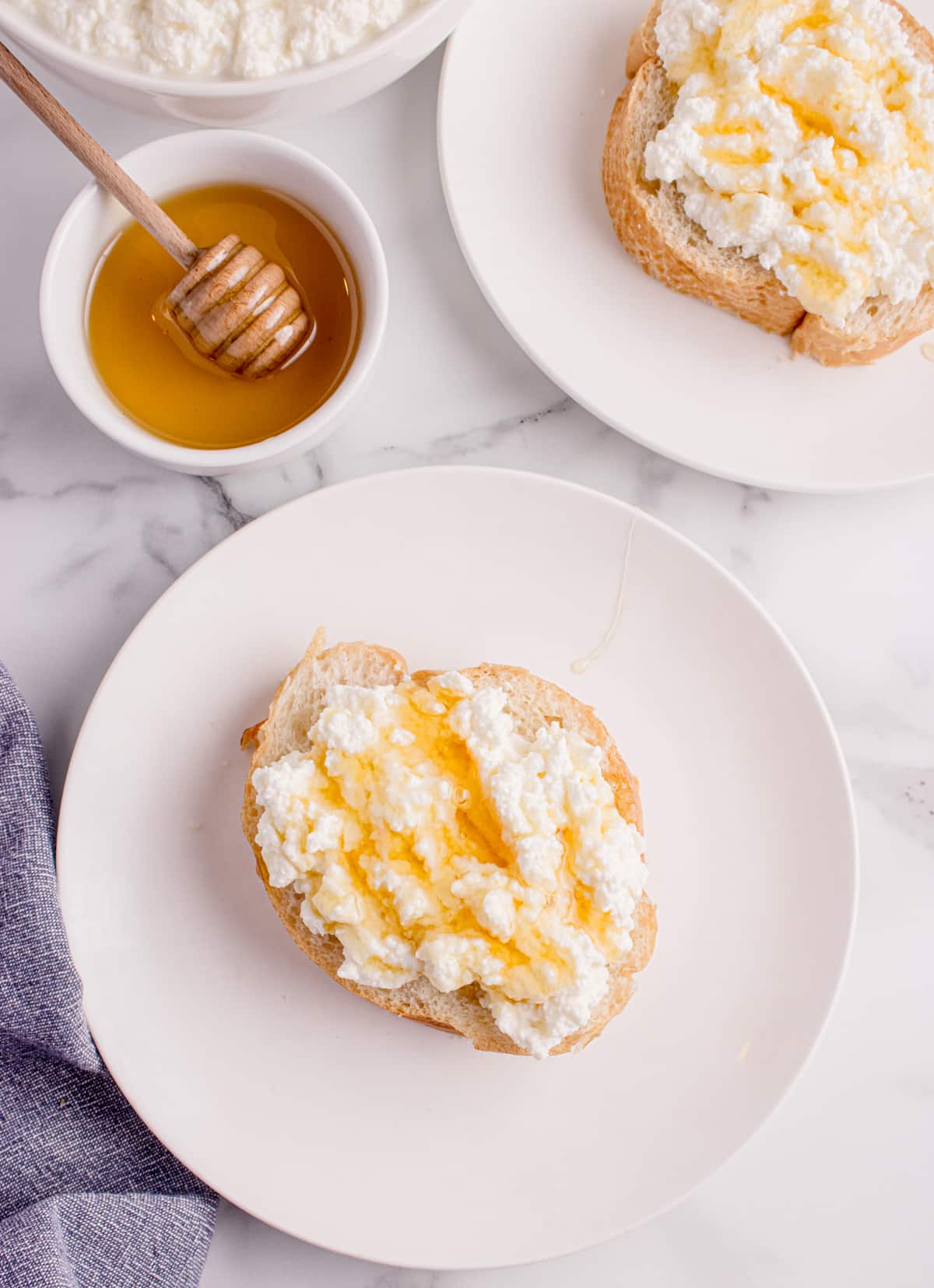 Toasted bread topped with fresh ricotta and finished with a drizzle of honey Fresh ricotta on toasted bread with honey drizzle