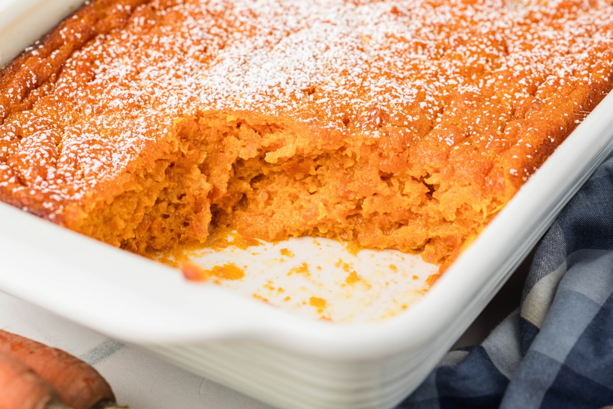 Carrot Souffle with spooned-out portion in baking dish Close-up of Carrot Souffle showing soft, custard-like center after serving