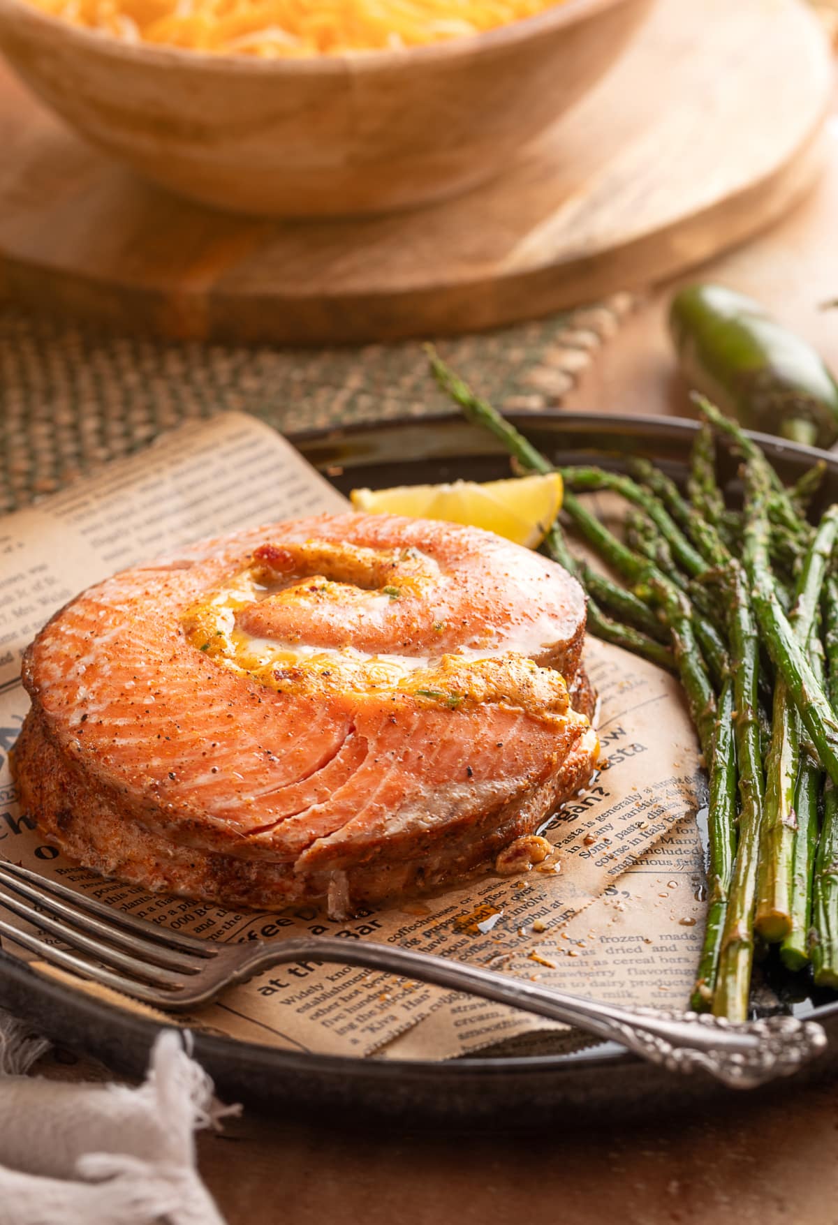 Baked salmon pinwheel made from a whole salmon fillet, filled with a creamy jalapeño popper-style mixture and served with roasted asparagus and lemon. Chipotle jalapeño popper stuffed salmon rolls baked and served with roasted asparagus