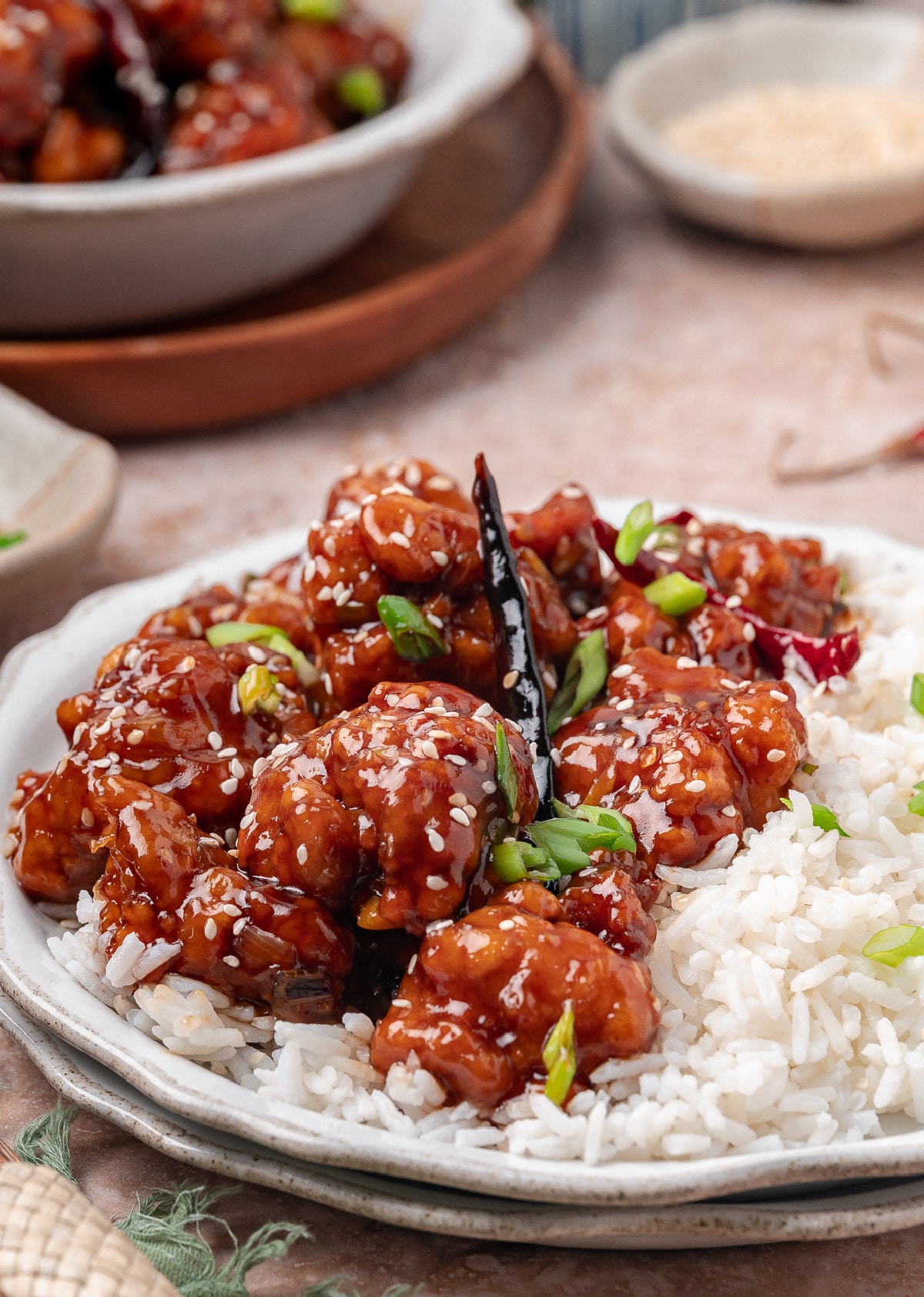 Crispy Chinese-American chicken served over steamed rice with scallions and sesame seeds
