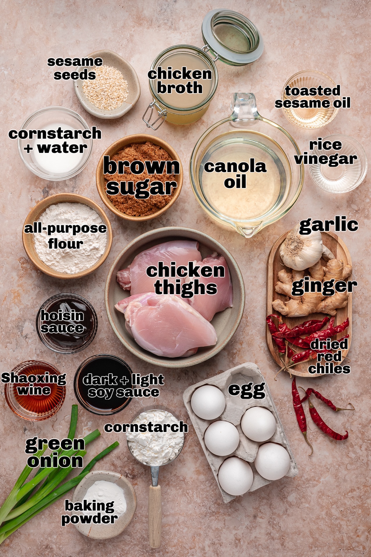 Ingredients for General Tso’s chicken including chicken thighs, soy sauce, brown sugar, garlic, ginger, and dried red chilies