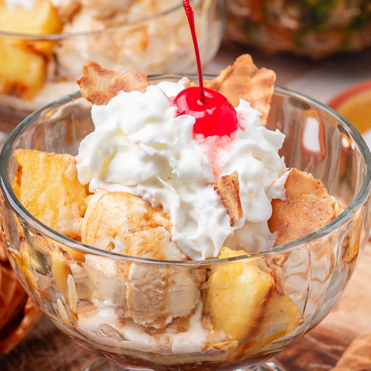 Grilled Pineapple Sundaes with Hot Buttered Rum Sauce and caramelized pineapple chunks
