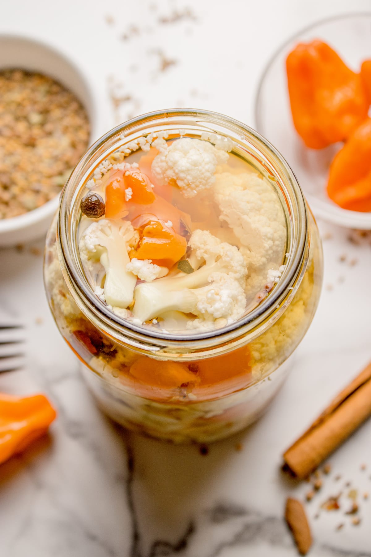 Jar of quick pickled cauliflower in vinegar brine Homemade spicy cauliflower refrigerator pickles with habanero peppers and whole spices