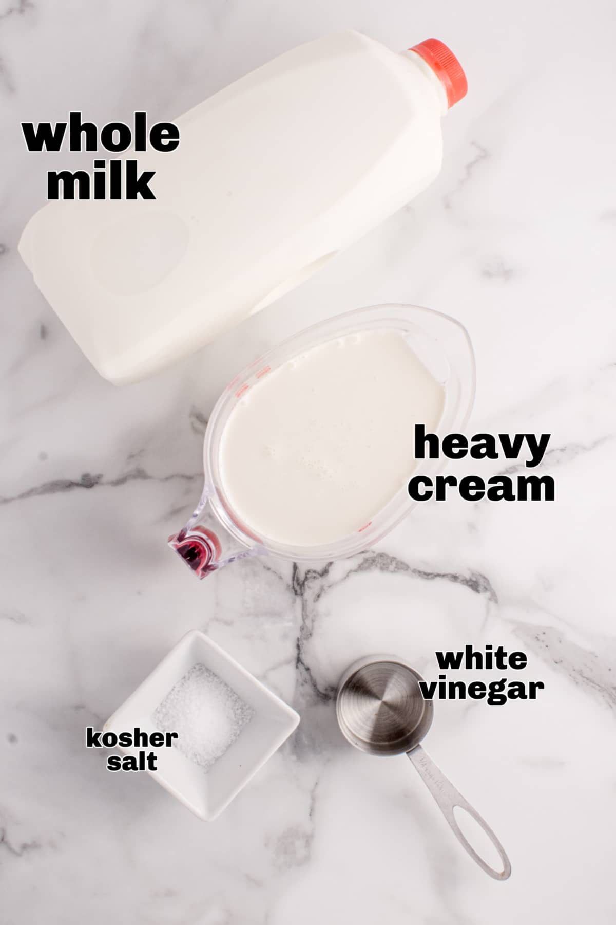 Whole milk, heavy cream, white vinegar, and kosher salt measured for homemade ricotta cheese Ingredients for homemade ricotta cheese including milk, cream, vinegar, and salt
