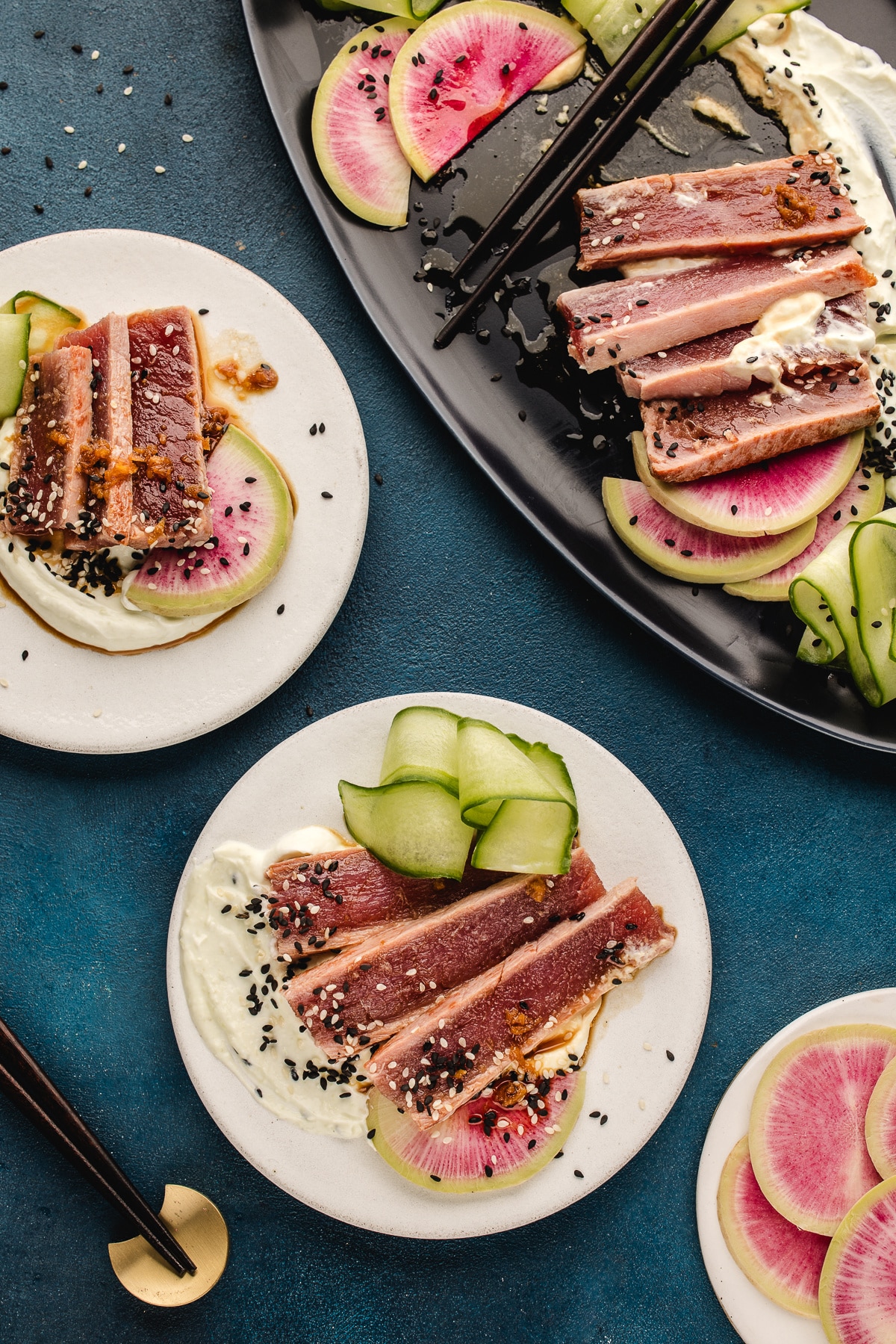 Seared ahi tuna plated with watermelon radish, cucumber ribbons, and wasabi yogurt