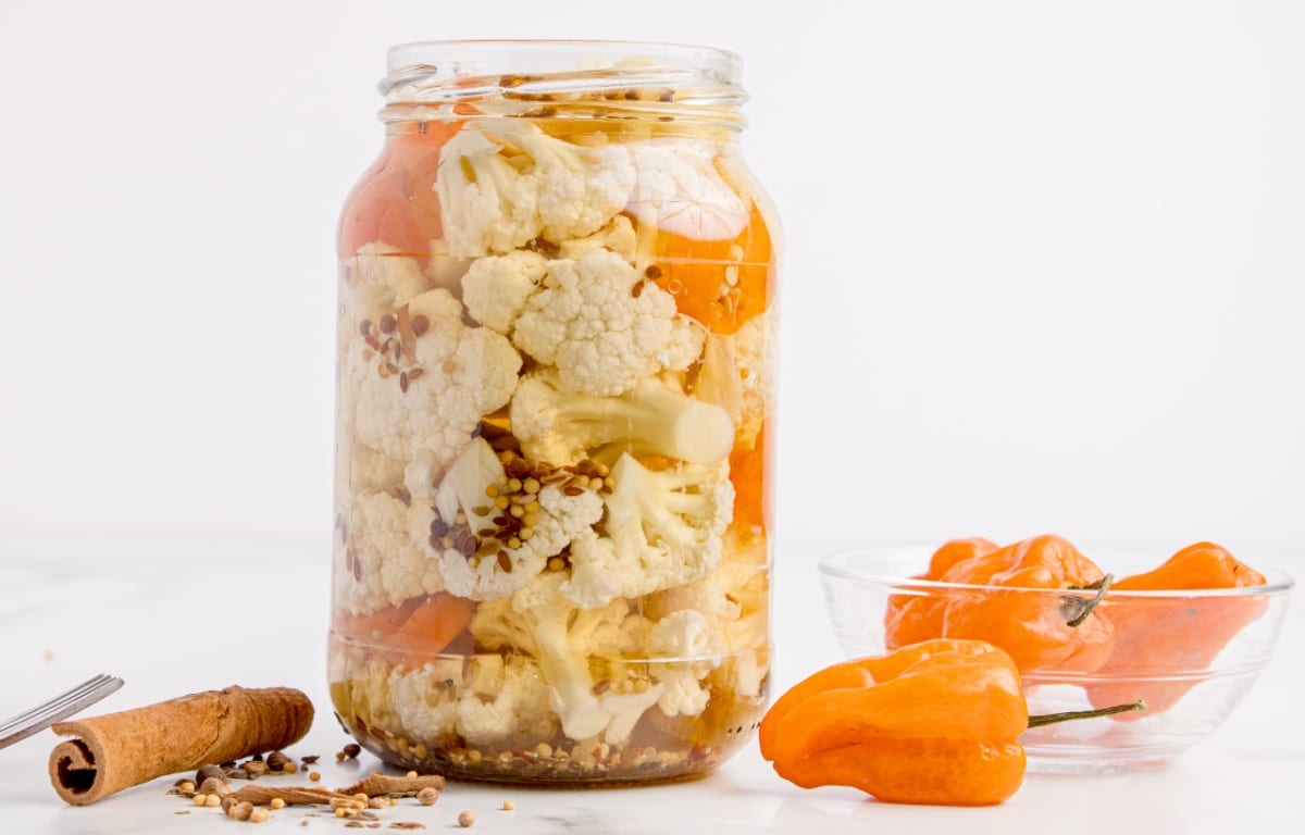 Refrigerator pickled cauliflower with habaneros and vinegar brine Spicy pickled cauliflower packed in a mason jar with habanero peppers and whole pickling spices