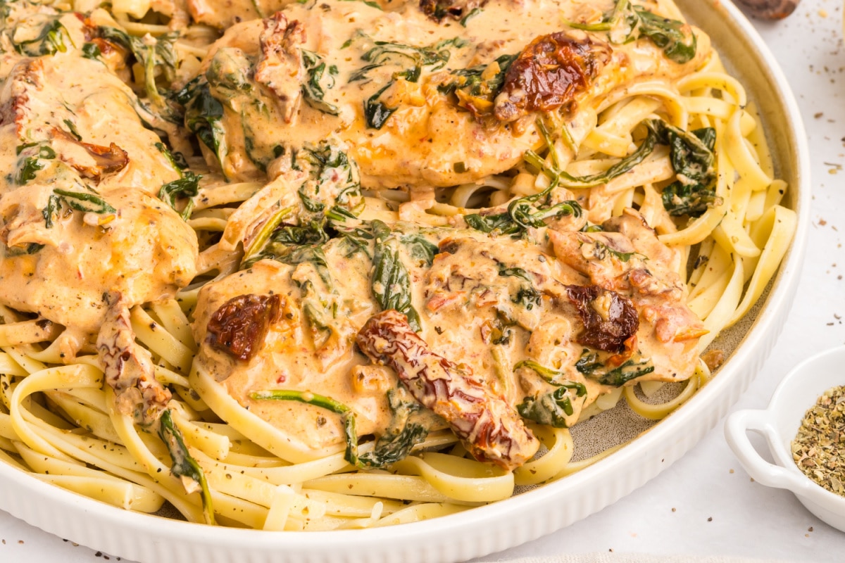 creamy tuscan chicken over pasta with spinach creamy tuscan chicken over pasta with sun-dried tomatoes, spinach, and parmesan sauce